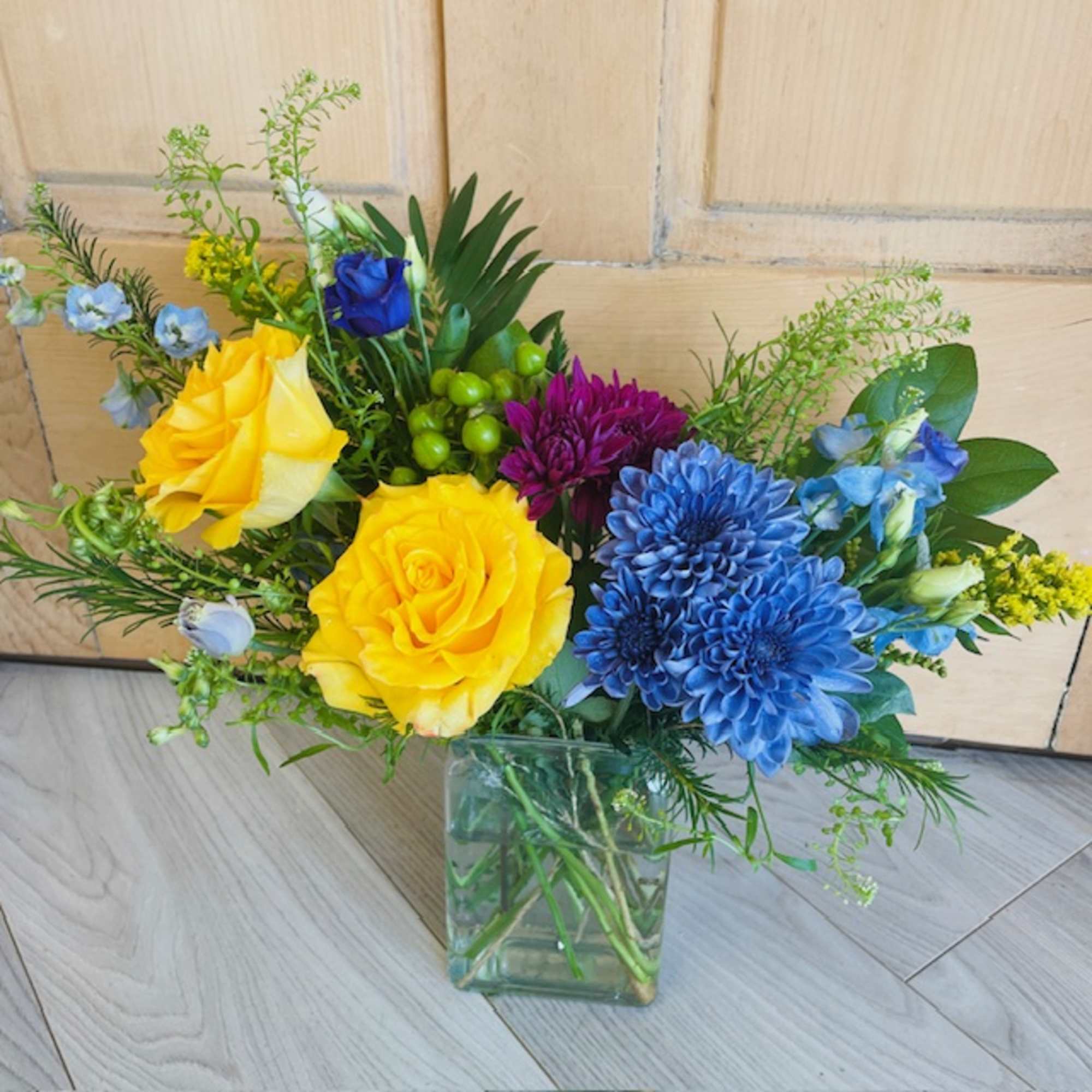 A selection of bright and cheerful flowers arranged in a vase or