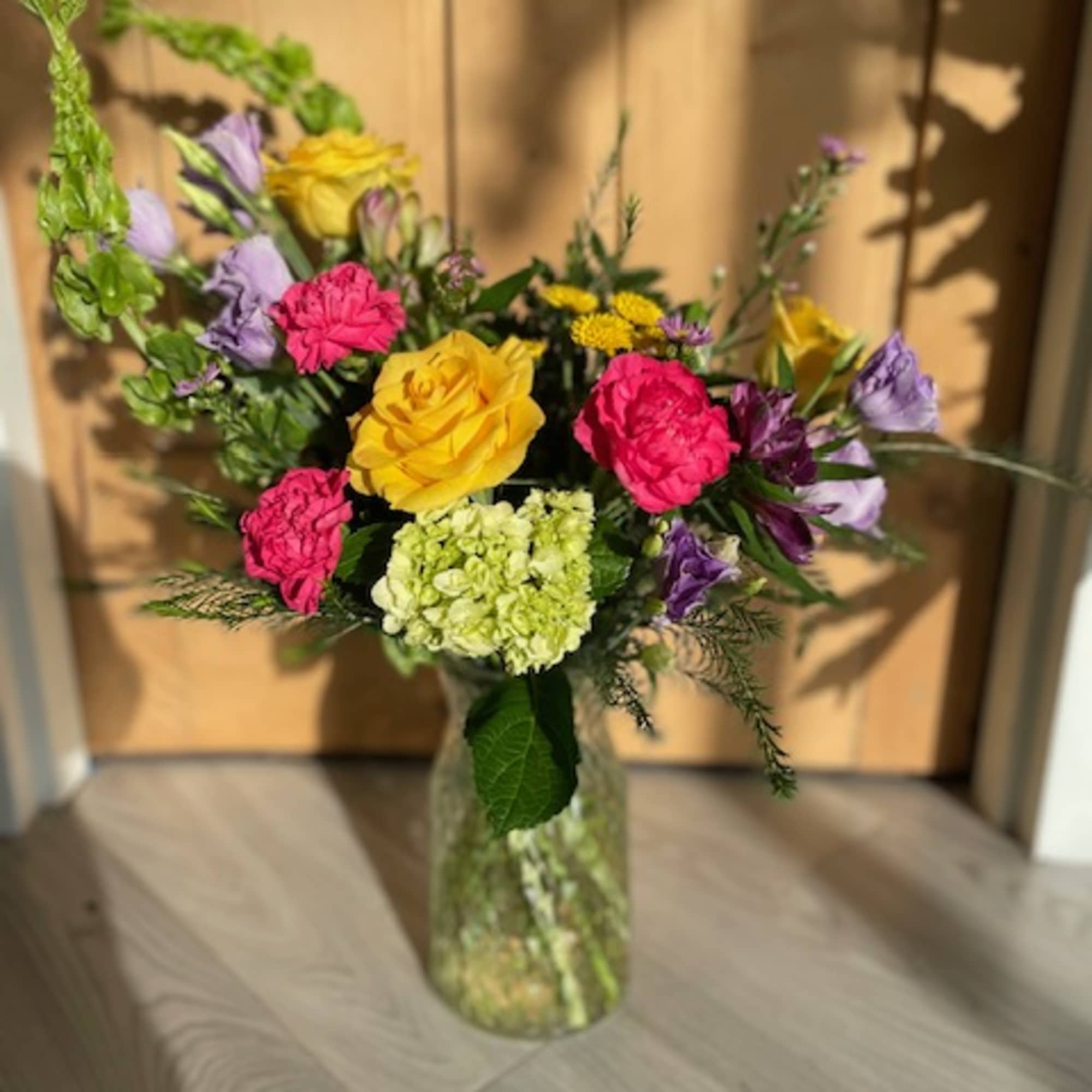 A selection of bright and cheerful flowers arranged in a vase or