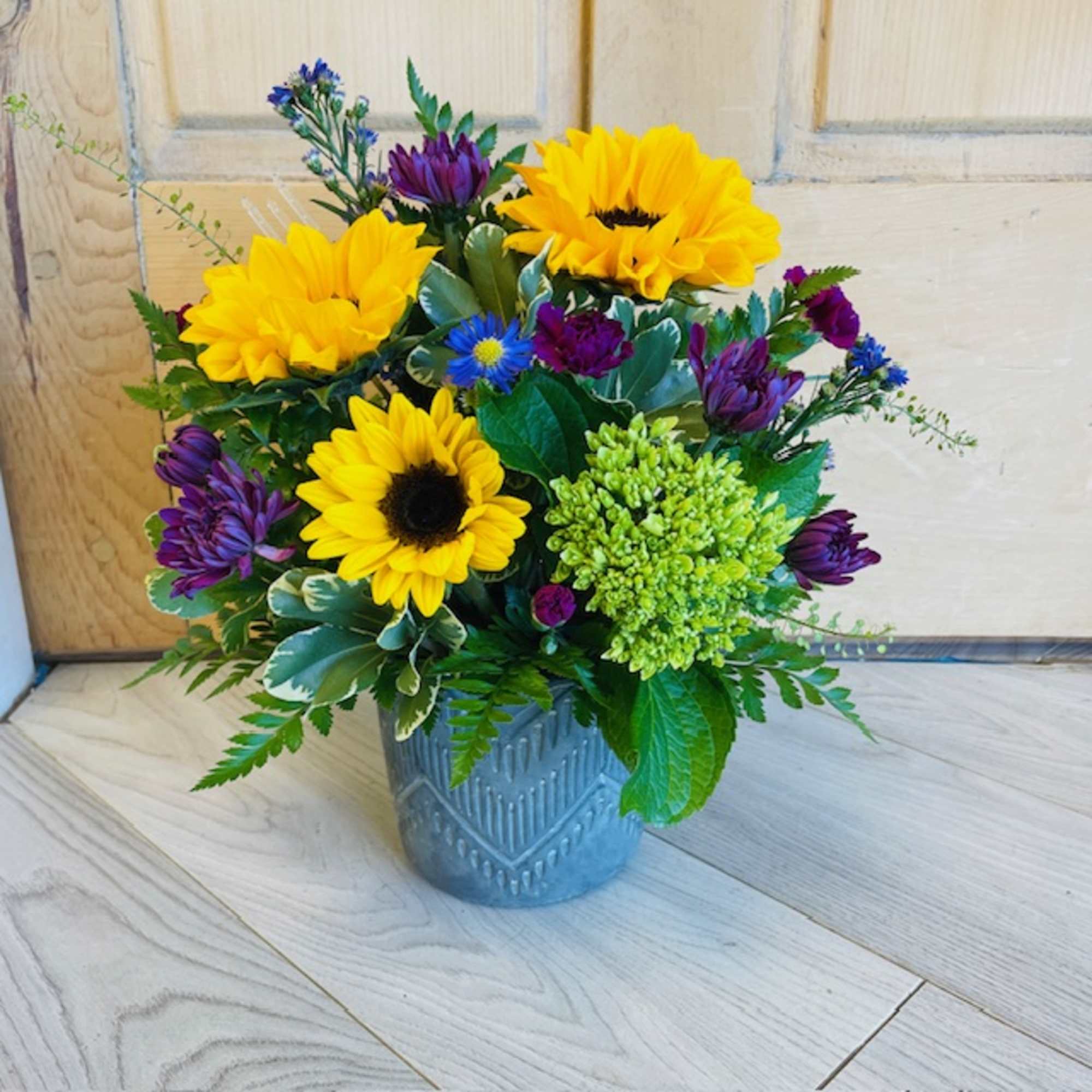 A selection of bright and cheerful flowers arranged in a vase or