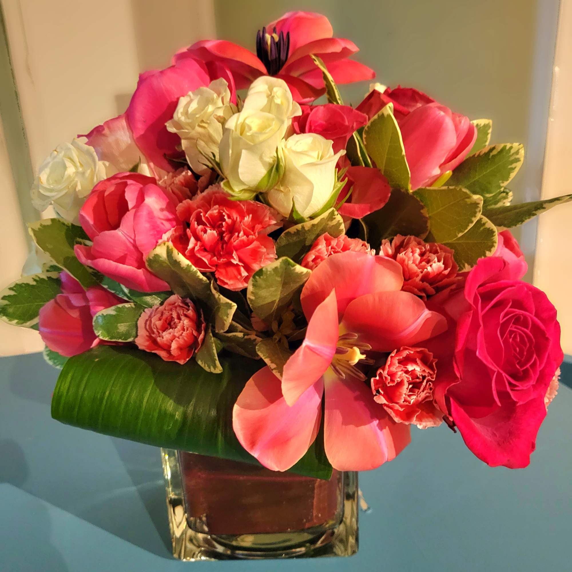 A collection of garden greens with Pink tulips and pink spray roses