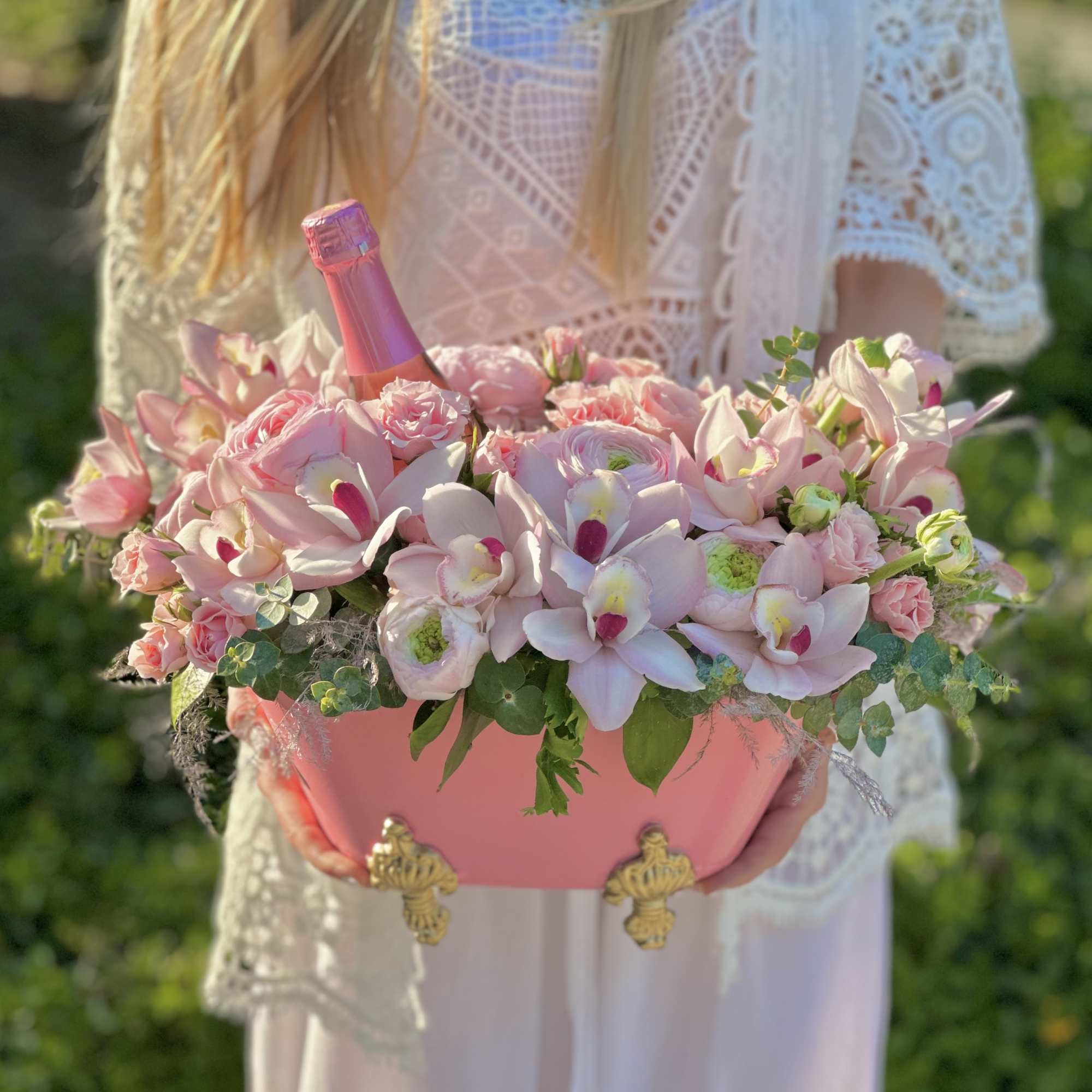 In a bath filled with delicate fragrances, elegant pink roses and cymbidium