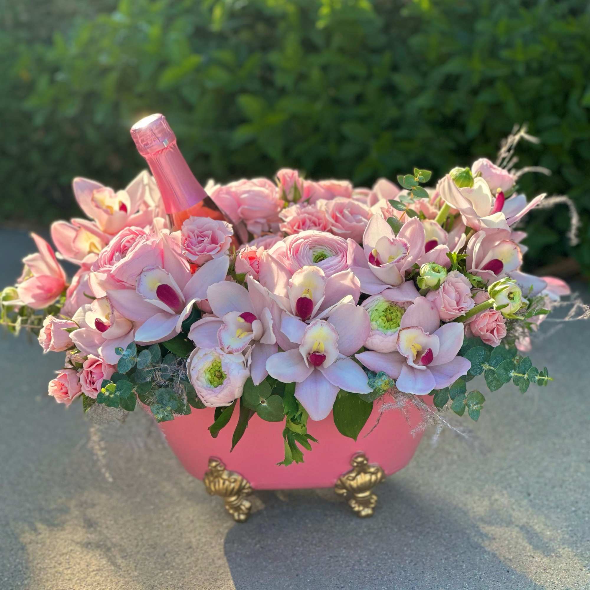 In a bath filled with delicate fragrances, elegant pink roses and cymbidium