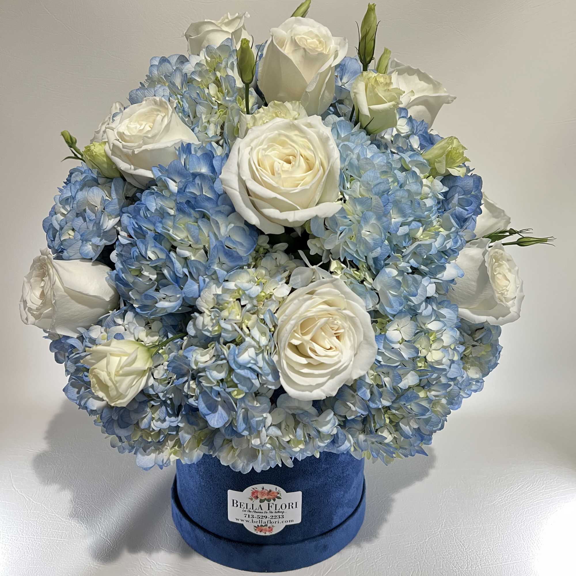 Velvet Blue Round gift box With Blue Hydrangeas and White Roses.