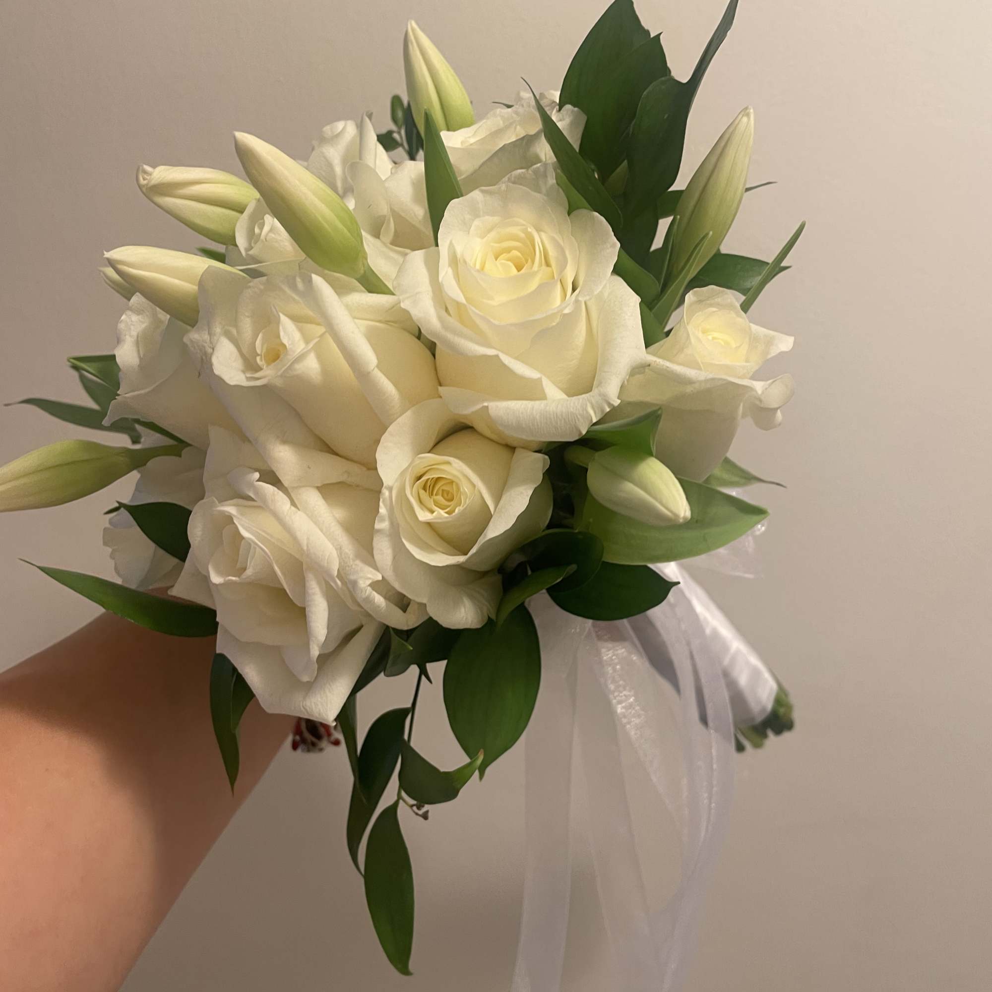 A classic white rose bouquet hand tied with ribbon. The perfect accessory