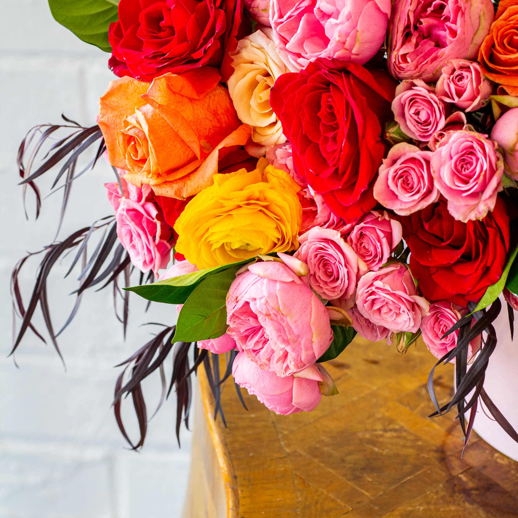 The &quot;Let&#039;s Stay Together&quot; floral arrangement bursts with colorful roses, garden roses