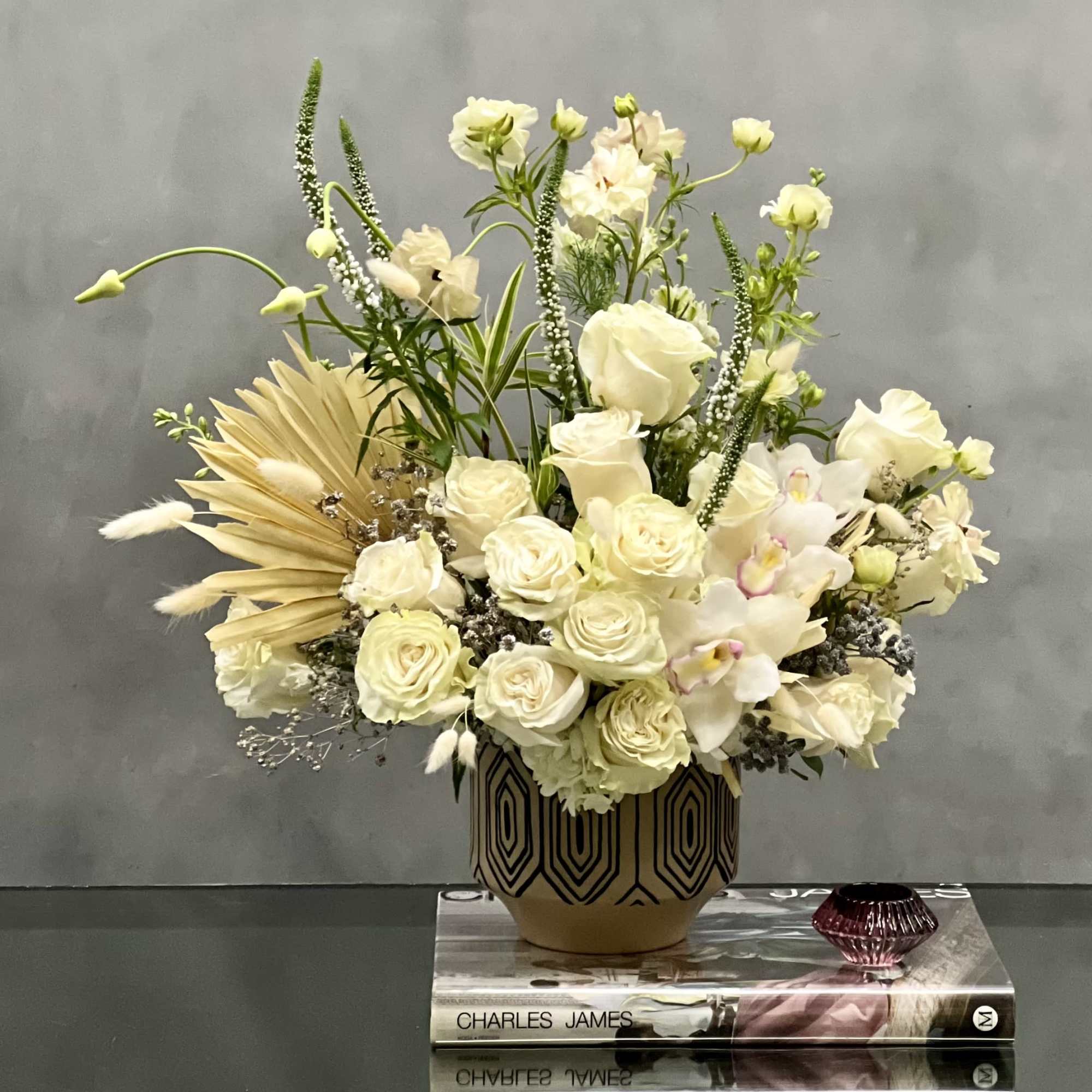 This arrangement is made with a designer&#039;s choice array of seasonal white
