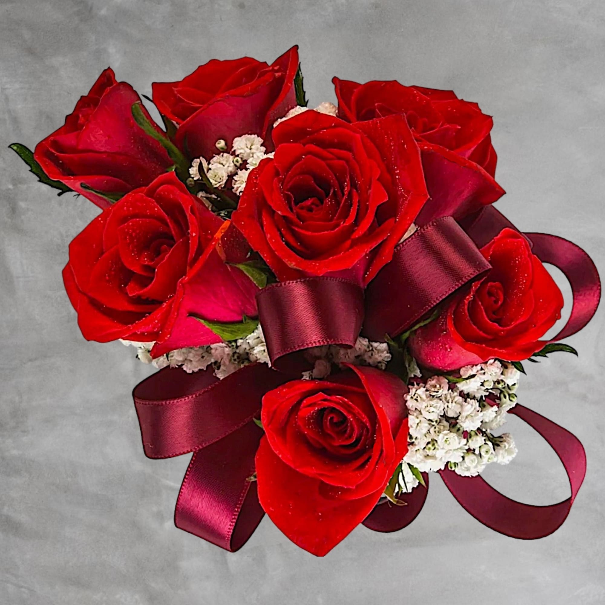 A classic red rose and baby&#039;s breath corsage compliments any outfit. Perfect