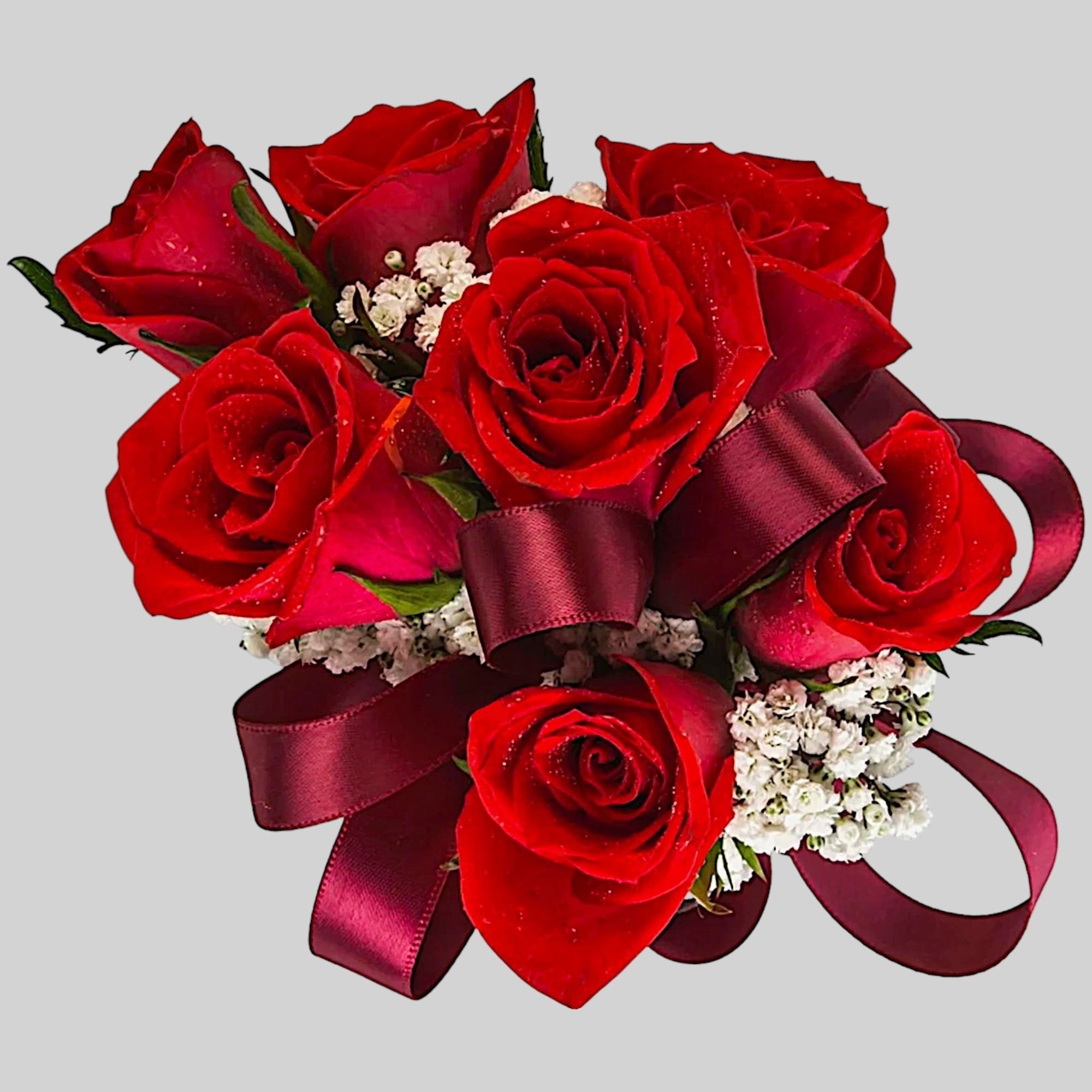 A classic red rose and baby&#039;s breath corsage compliments any outfit. Perfect