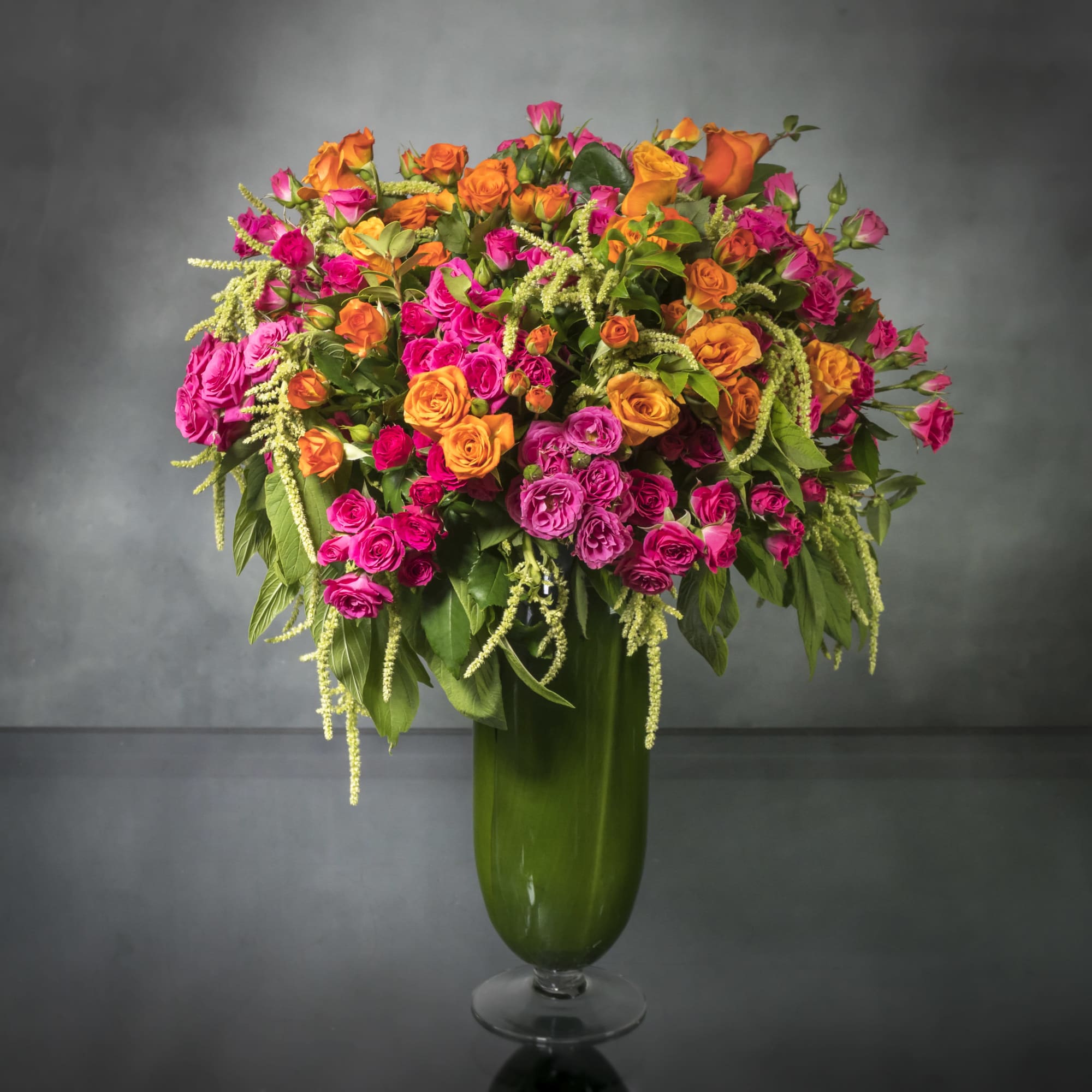 A vibrant mix of gorgeous orange and hot pink Roses in a