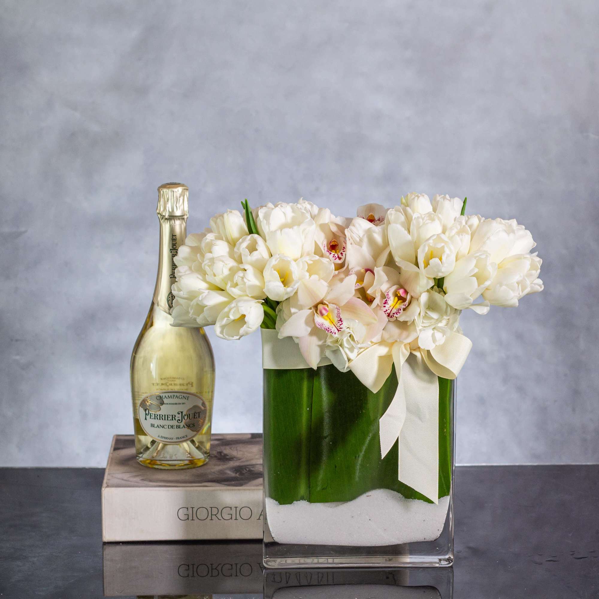 Delight in the serene beauty of this exquisite floral arrangement featuring a