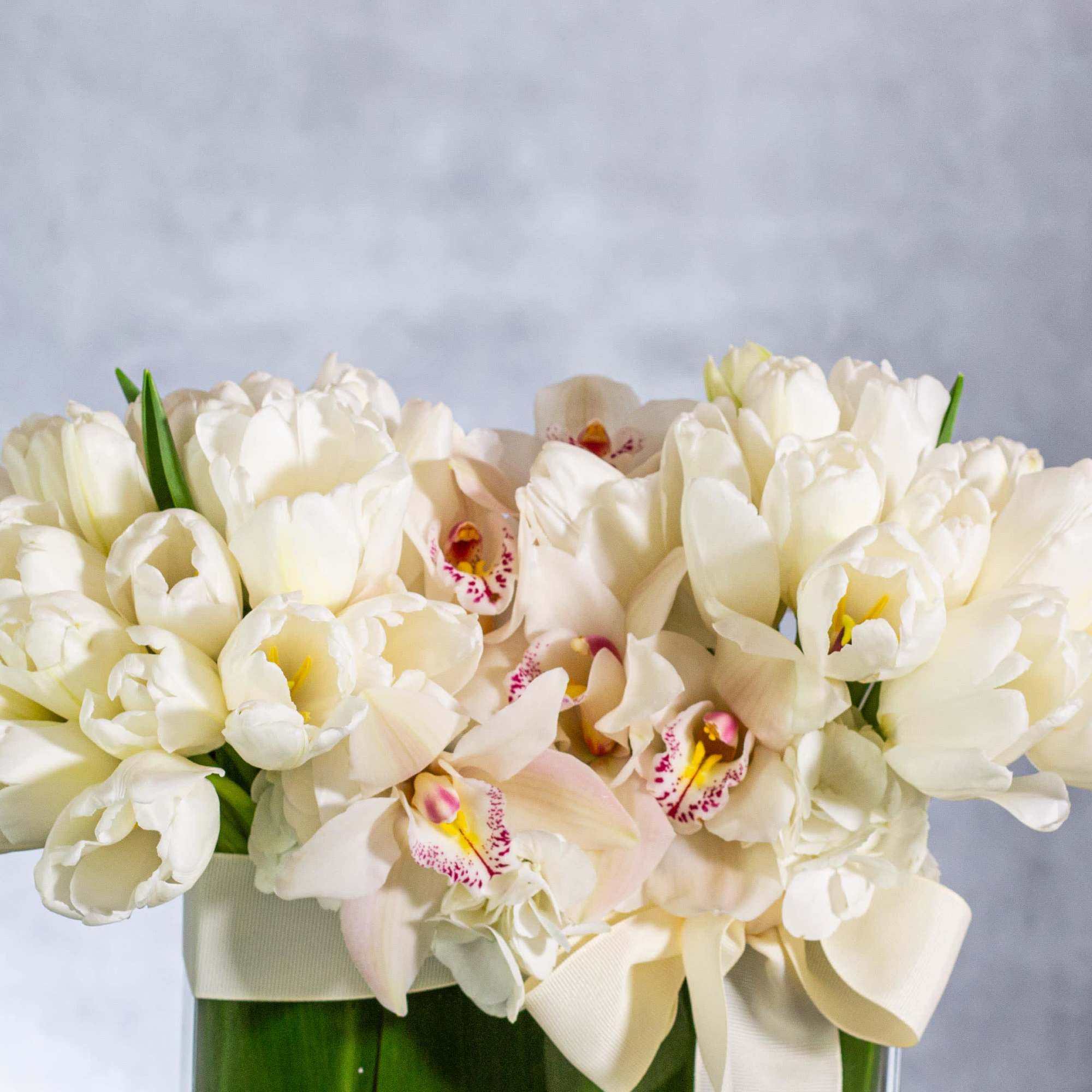 Delight in the serene beauty of this exquisite floral arrangement featuring a