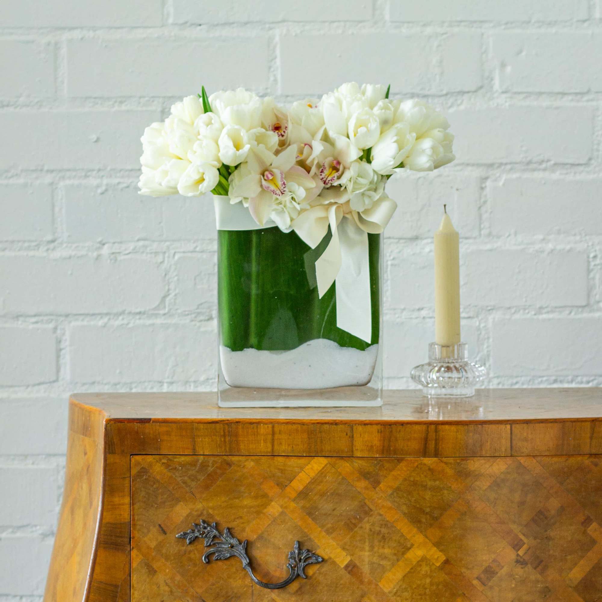 Delight in the serene beauty of this exquisite floral arrangement featuring a