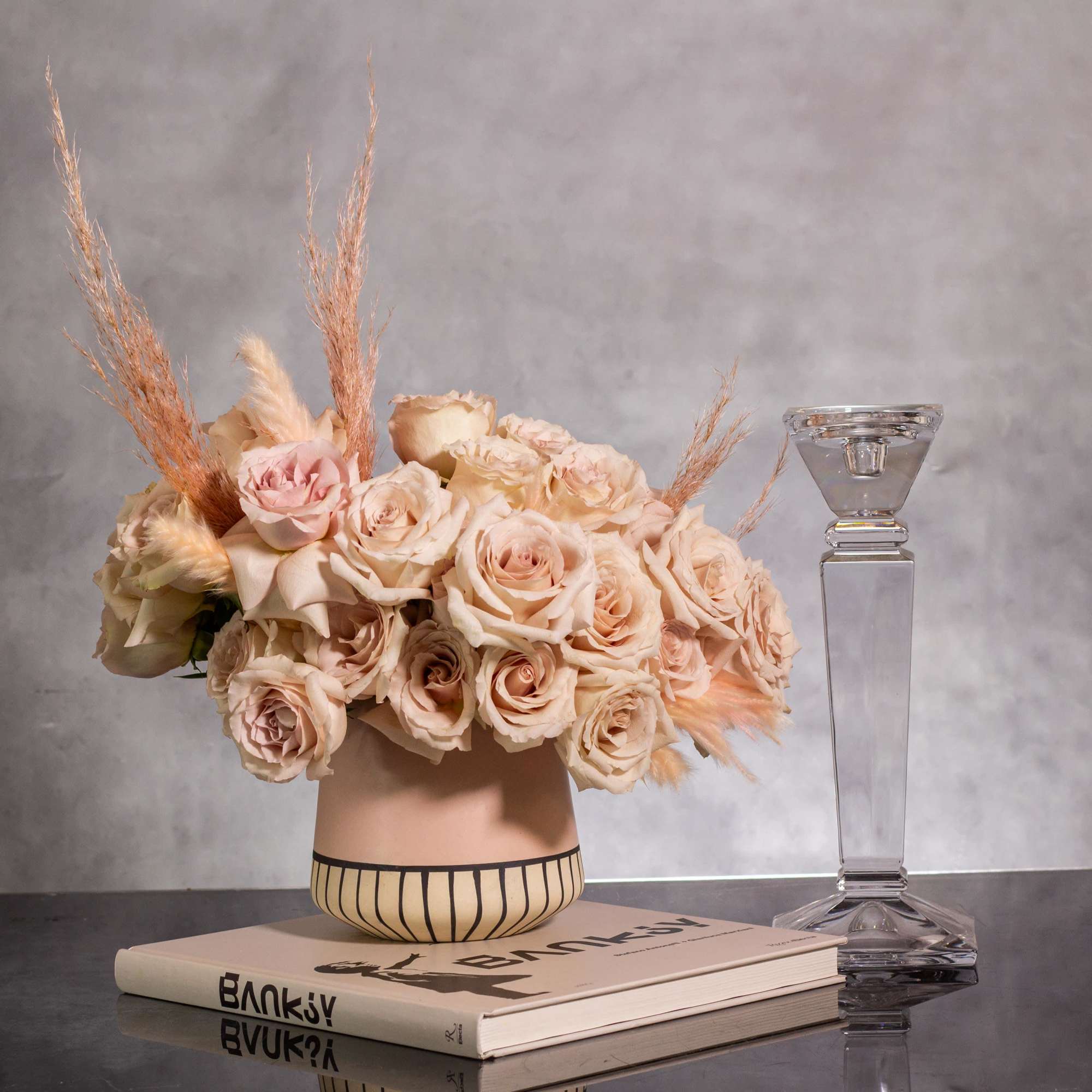 The sand color roses are elegantly displayed in a modern 6-inch tall
