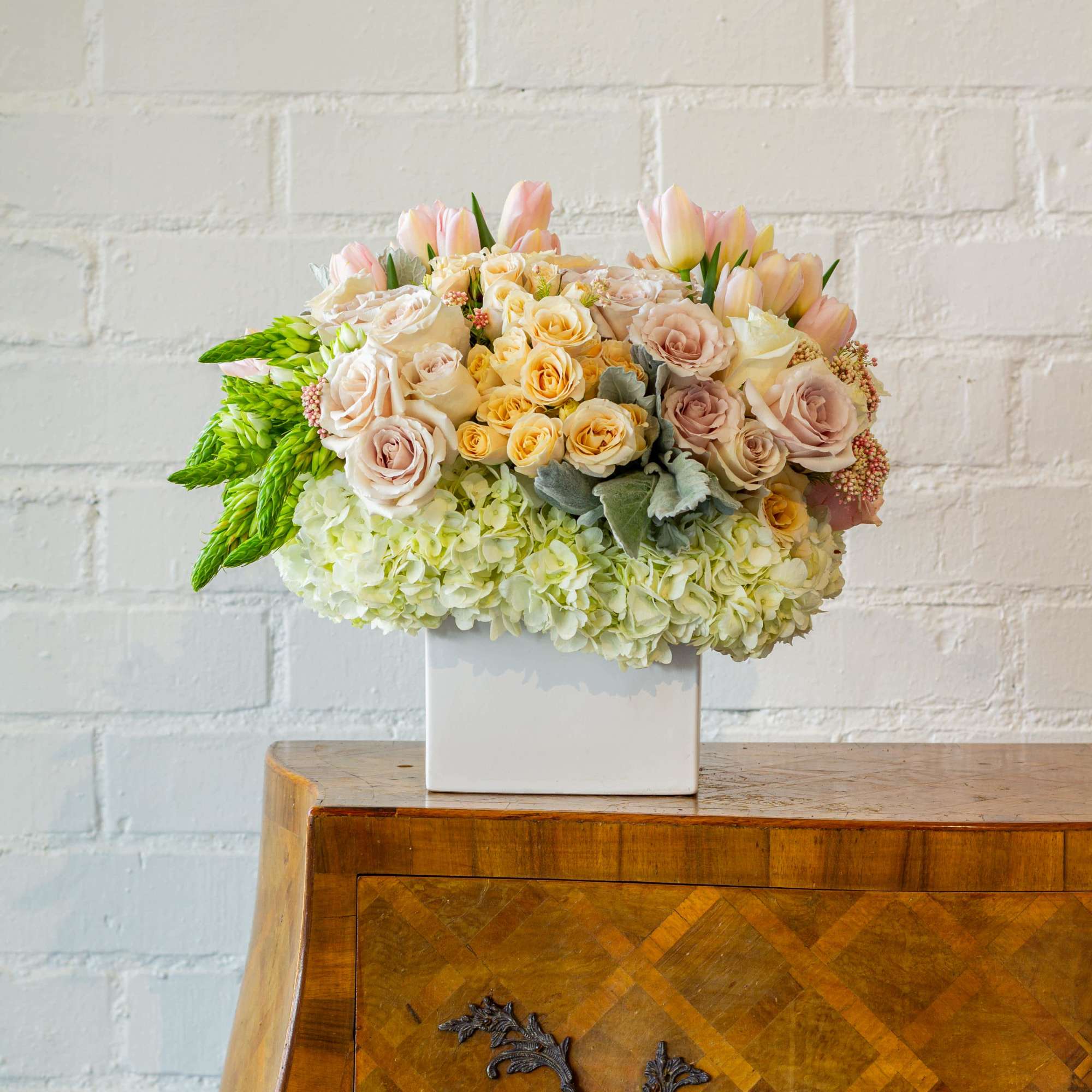  Delight in the gentle beauty of our floral arrangement, featuring soft