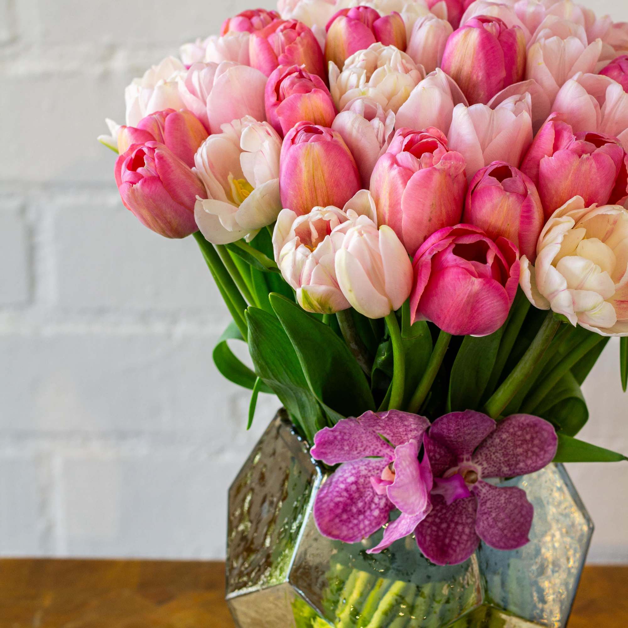 Envision a stunning floral arrangement comprised of fifty light pink and various