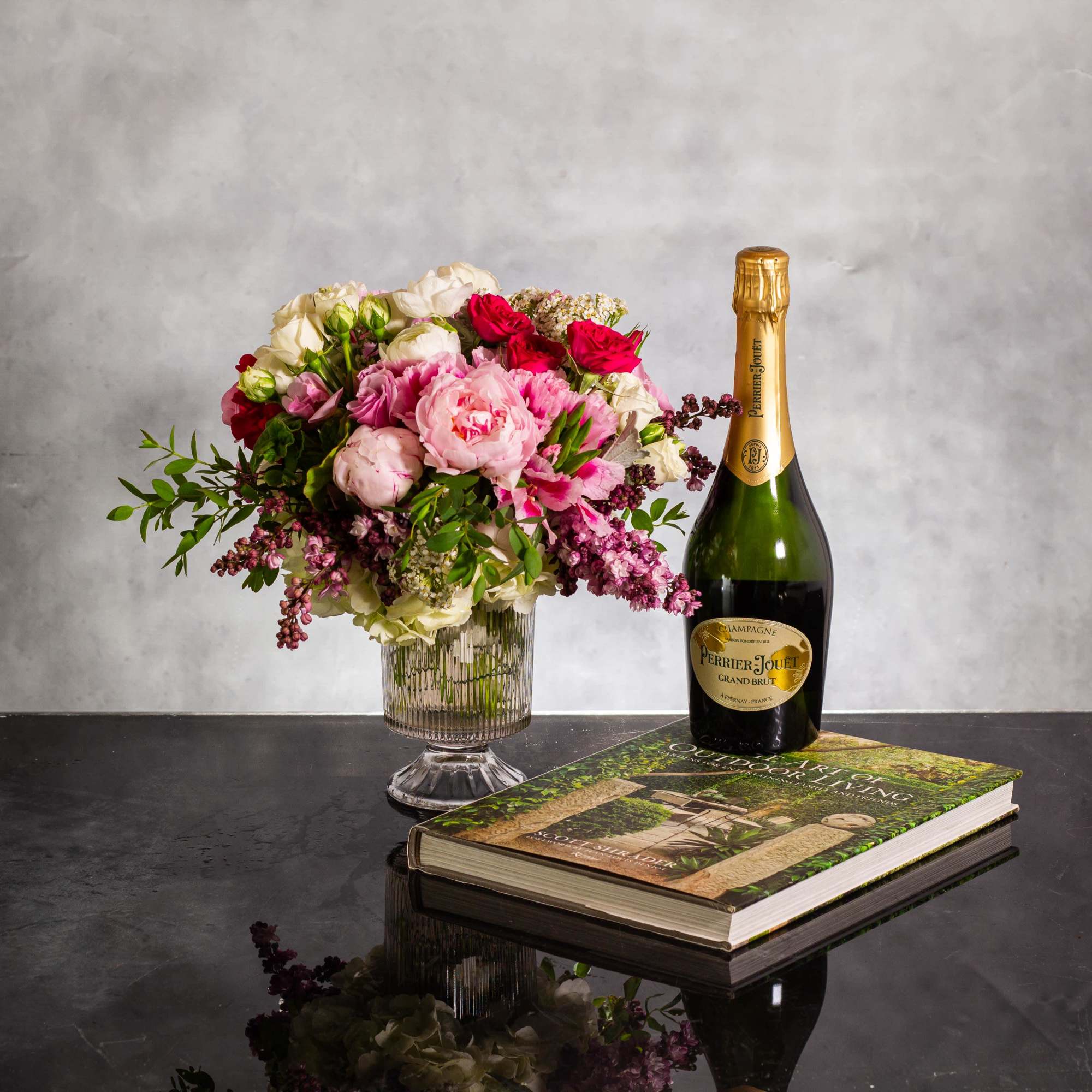 For this exquisite floral arrangement, envision a captivating blend of peonies, lilacs