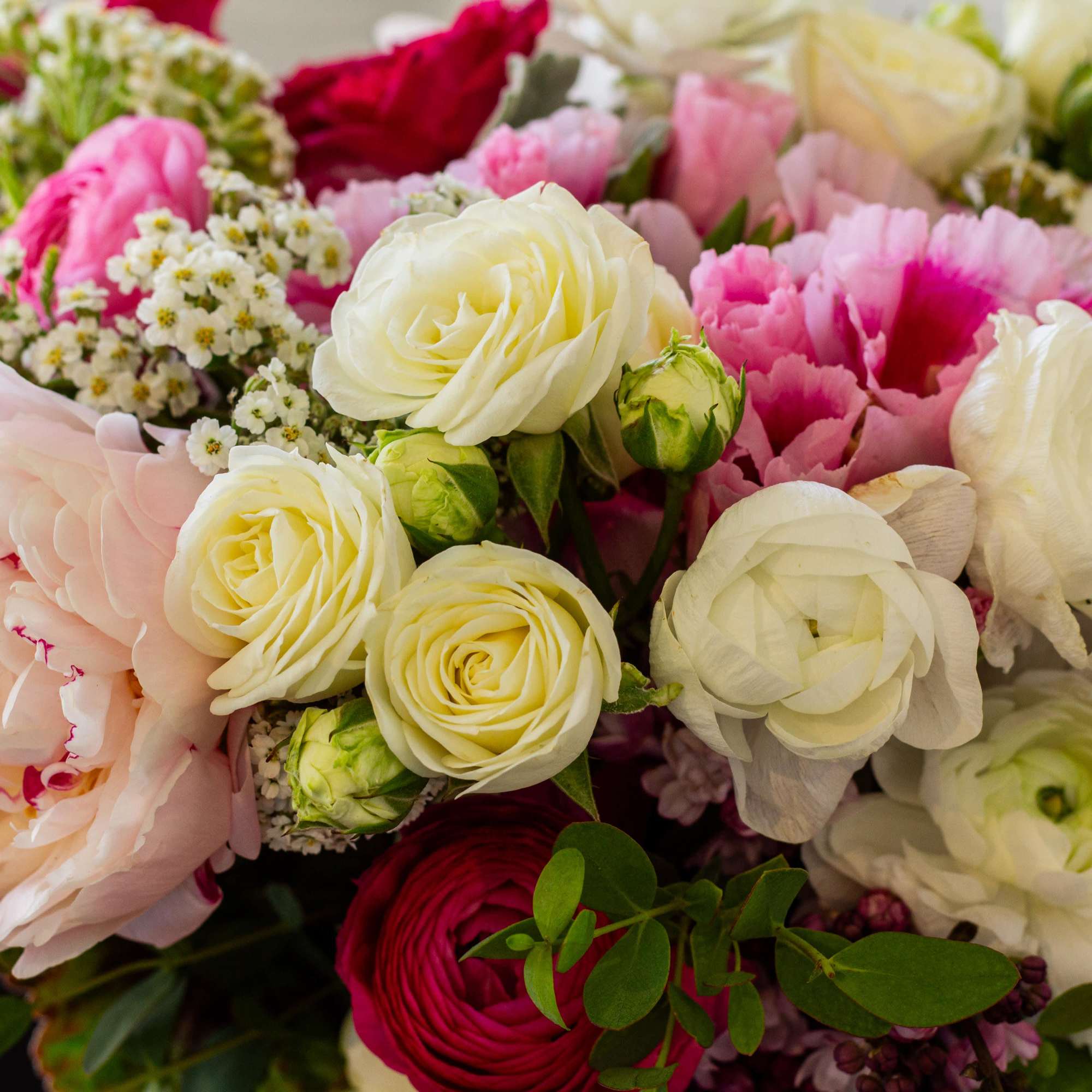 For this exquisite floral arrangement, envision a captivating blend of peonies, lilacs