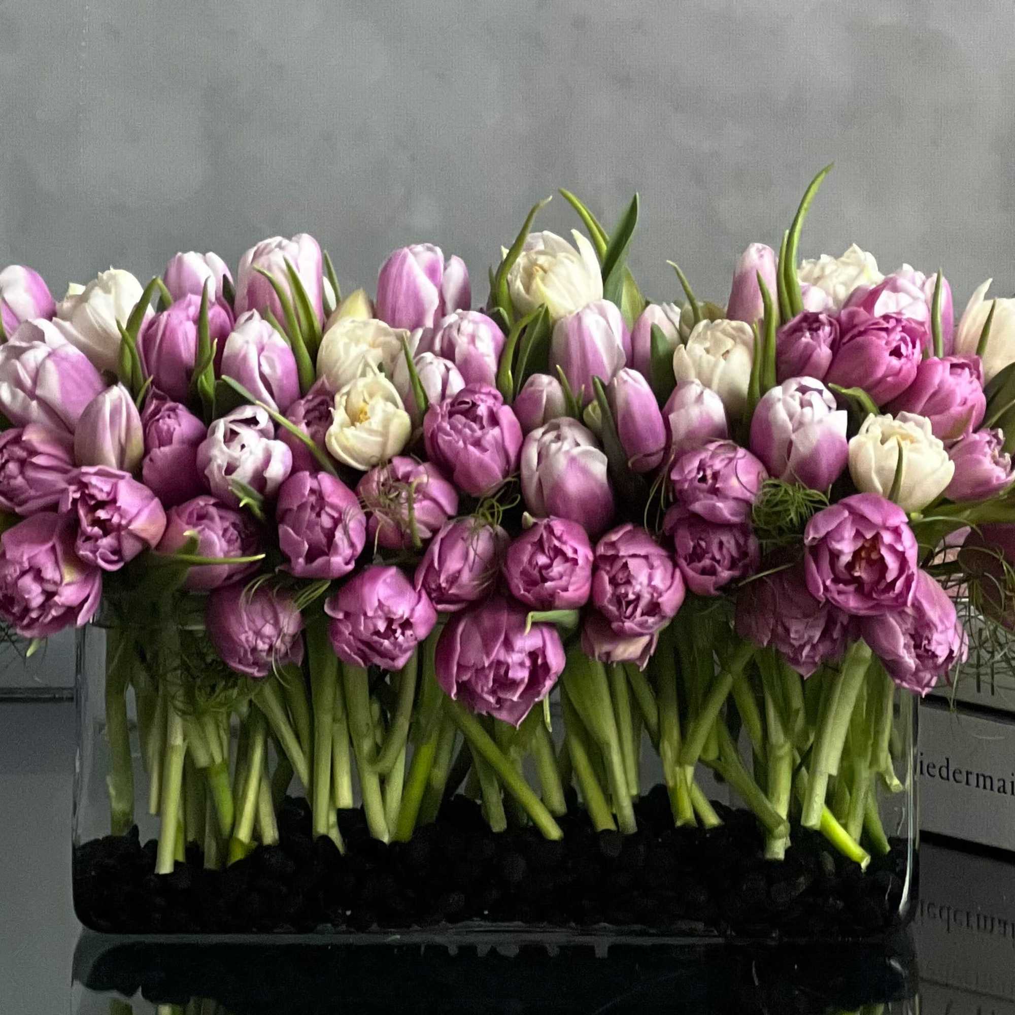 This modern low centerpiece of tulips will surely impressed anyone. Rows of