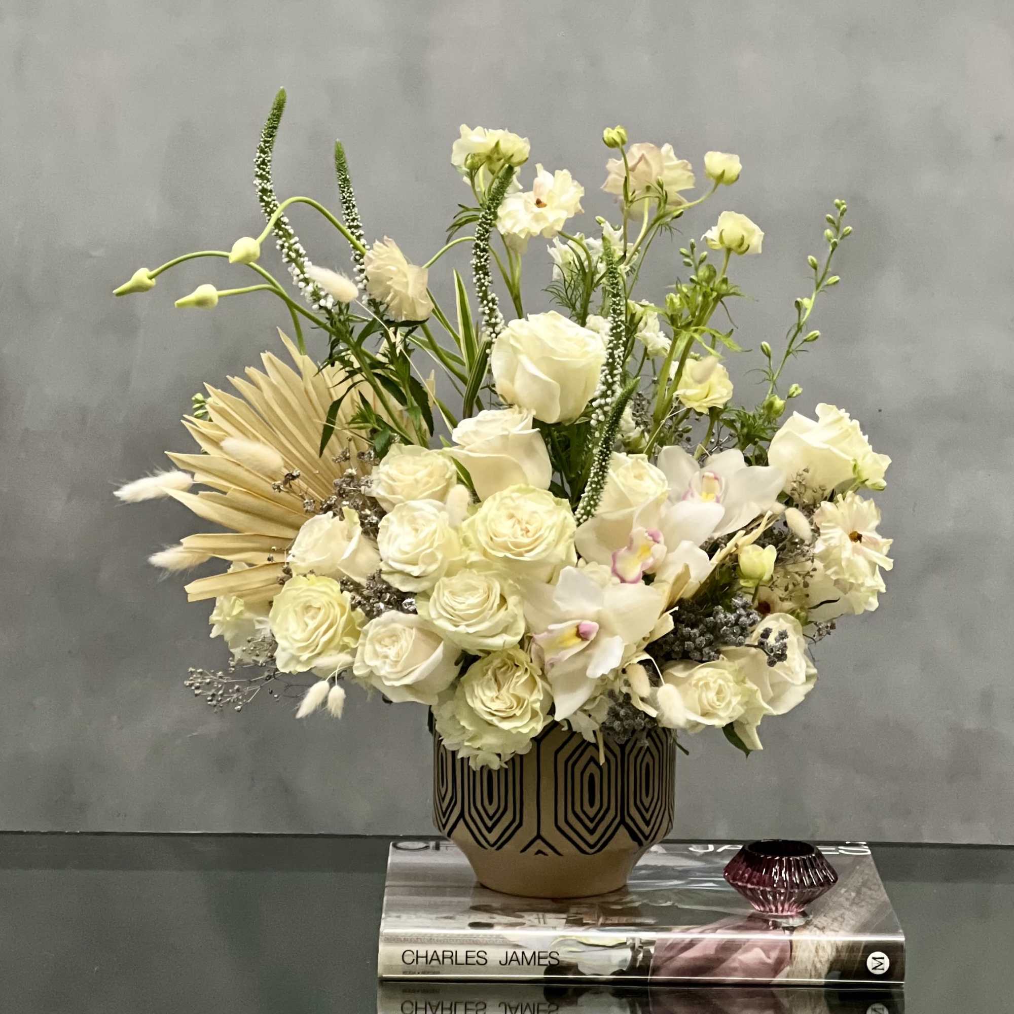 This arrangement is made with a designer&#039;s choice array of seasonal white