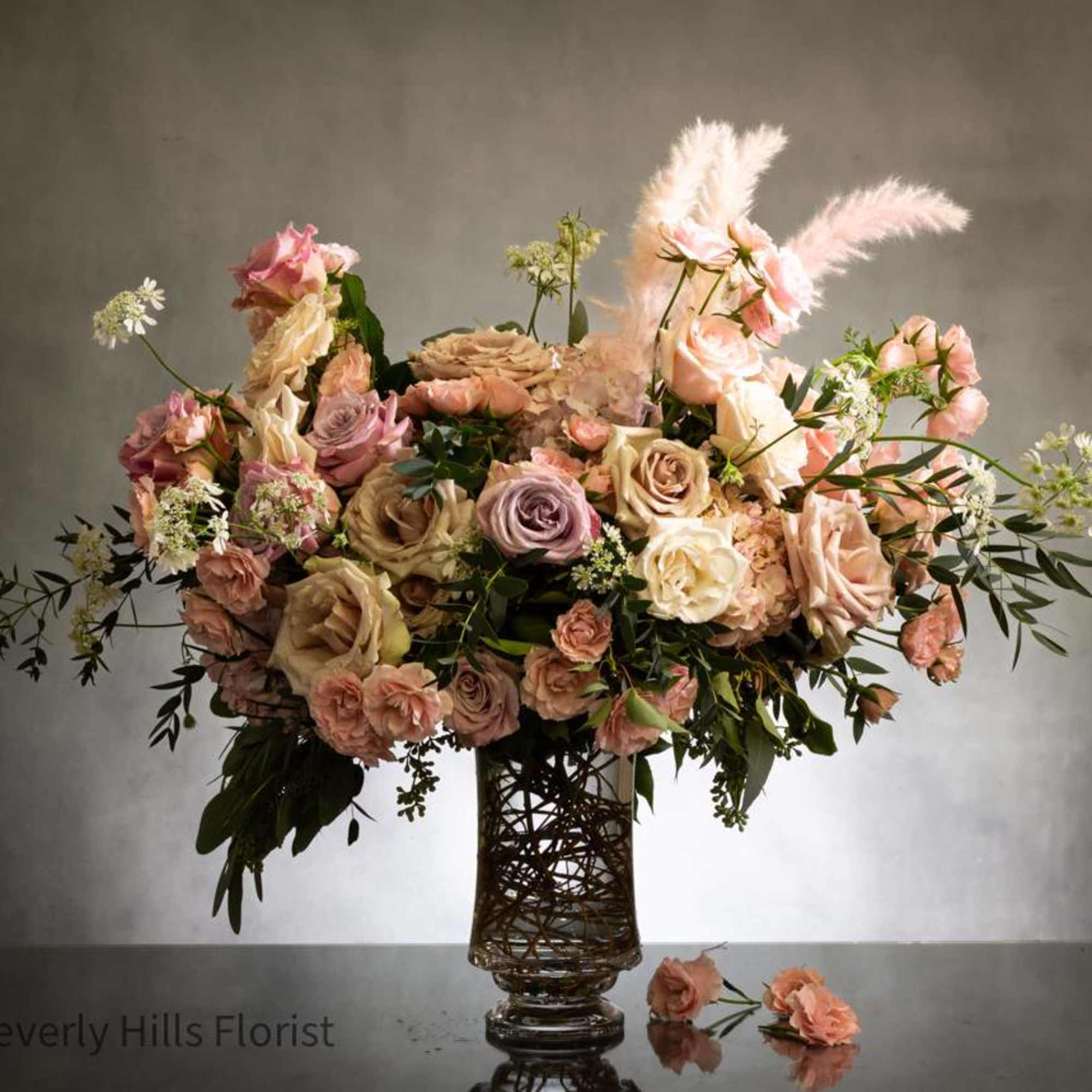 This stunning arrangement boasts over 100 blooms of gorgeous delicate florals, including