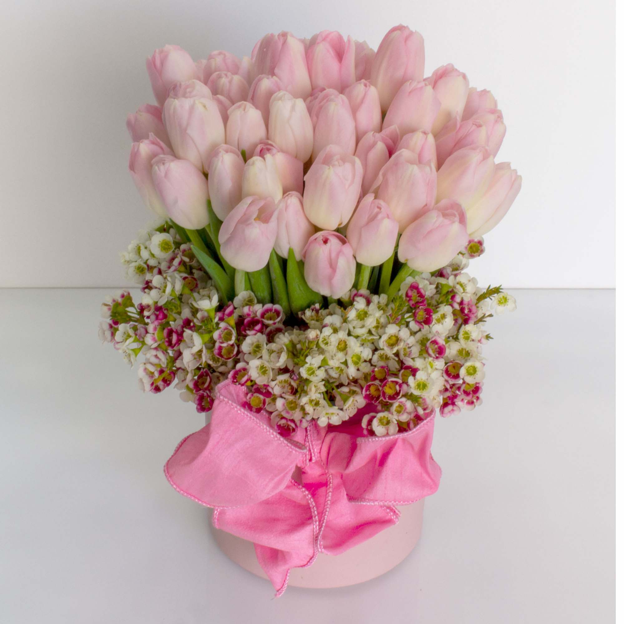 50. Blush Tulips in a ceramic vase 

Approx. 10-12&quot; Tall 

Standard -