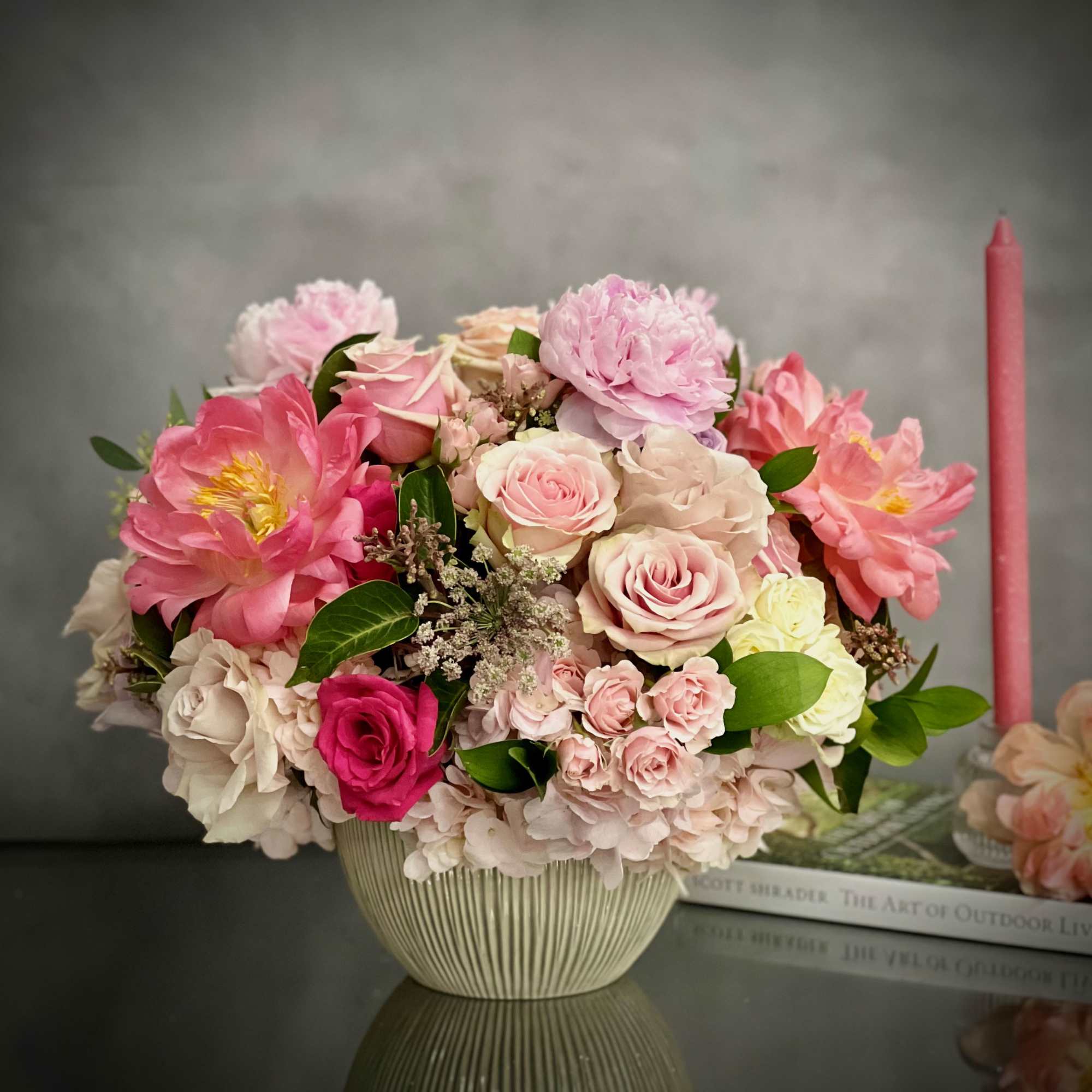 This round dish is abundantly filled with lovely Roses of varying hues