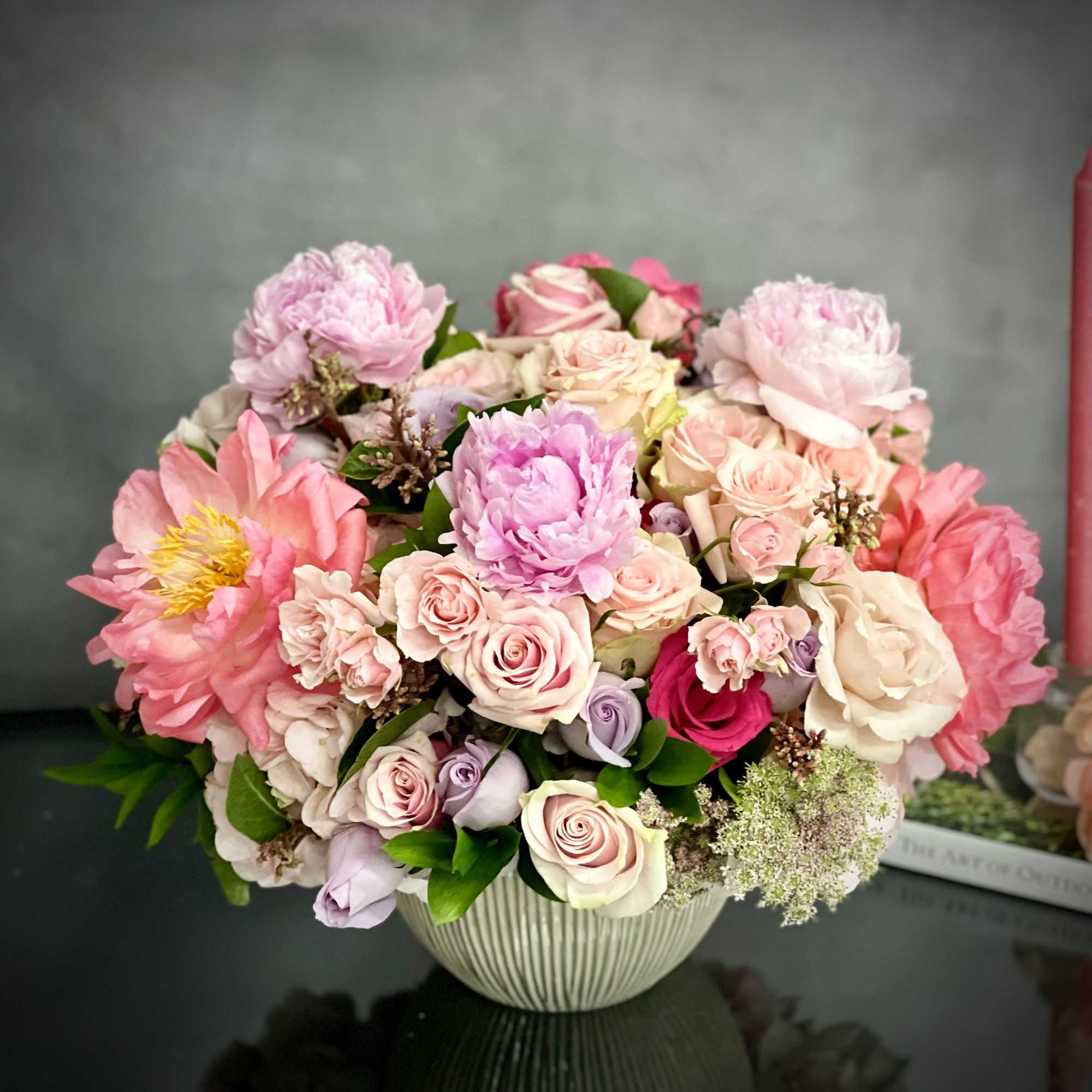 This round dish is abundantly filled with lovely Roses of varying hues