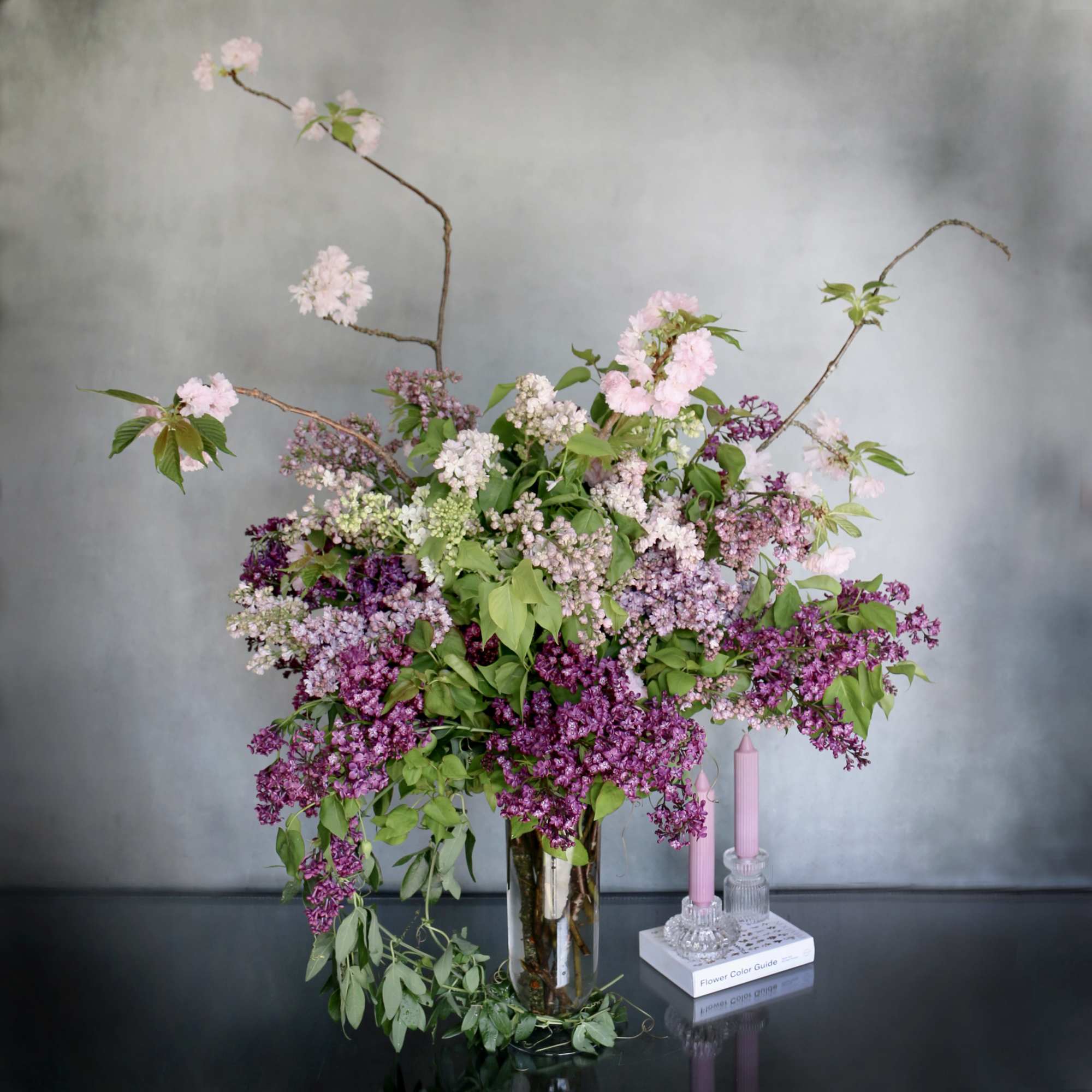 Purple shades of lilac paired with cherry blossom makes this arrangement eye