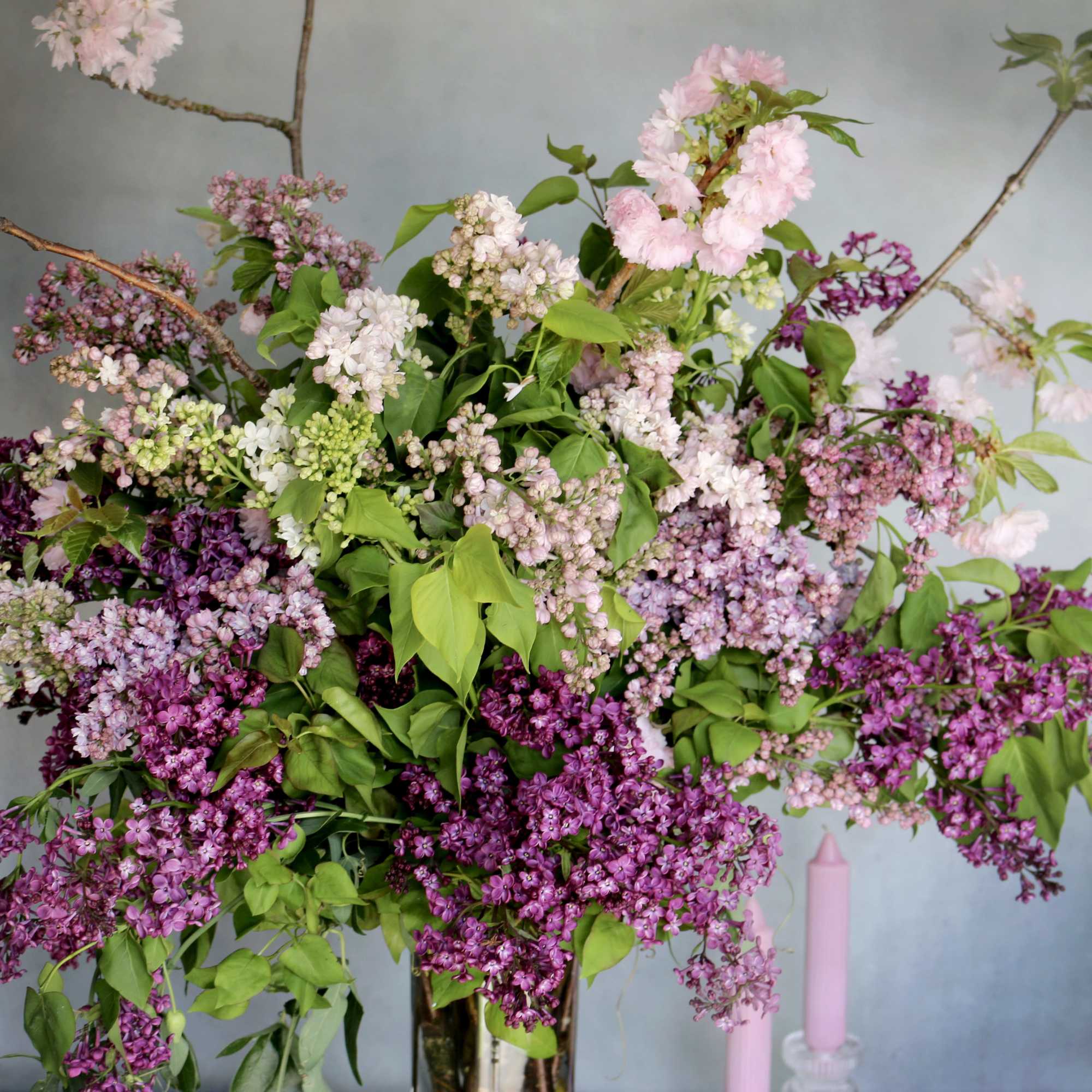 Purple shades of lilac paired with cherry blossom makes this arrangement eye