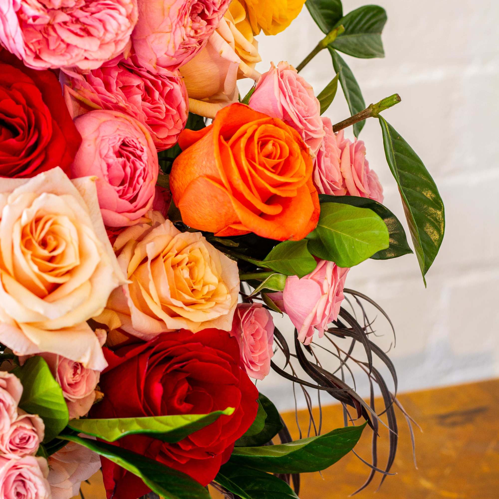 The &quot;Let&#039;s Stay Together&quot; floral arrangement bursts with colorful roses, garden roses