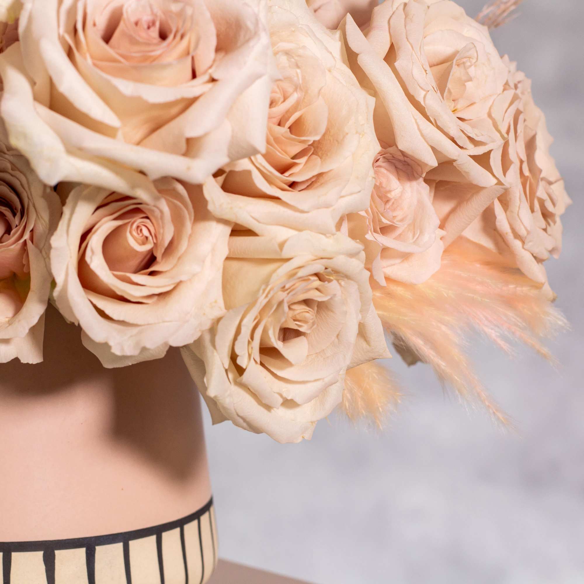 The sand color roses are elegantly displayed in a modern 6-inch tall