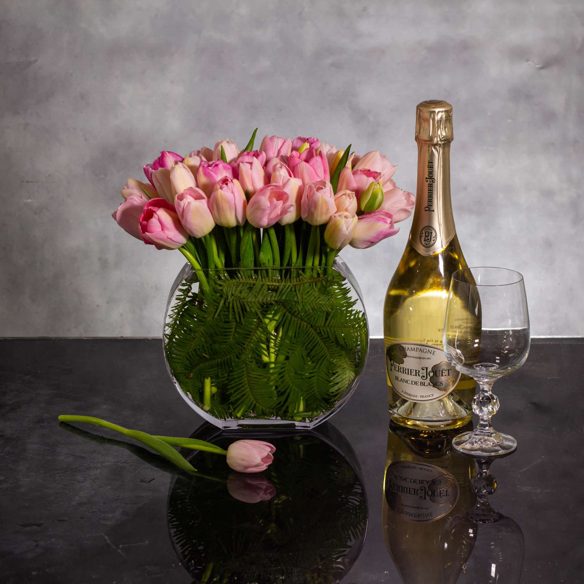 The beautiful arrangement showcases 50 tulips gathered in a modern vase, creating