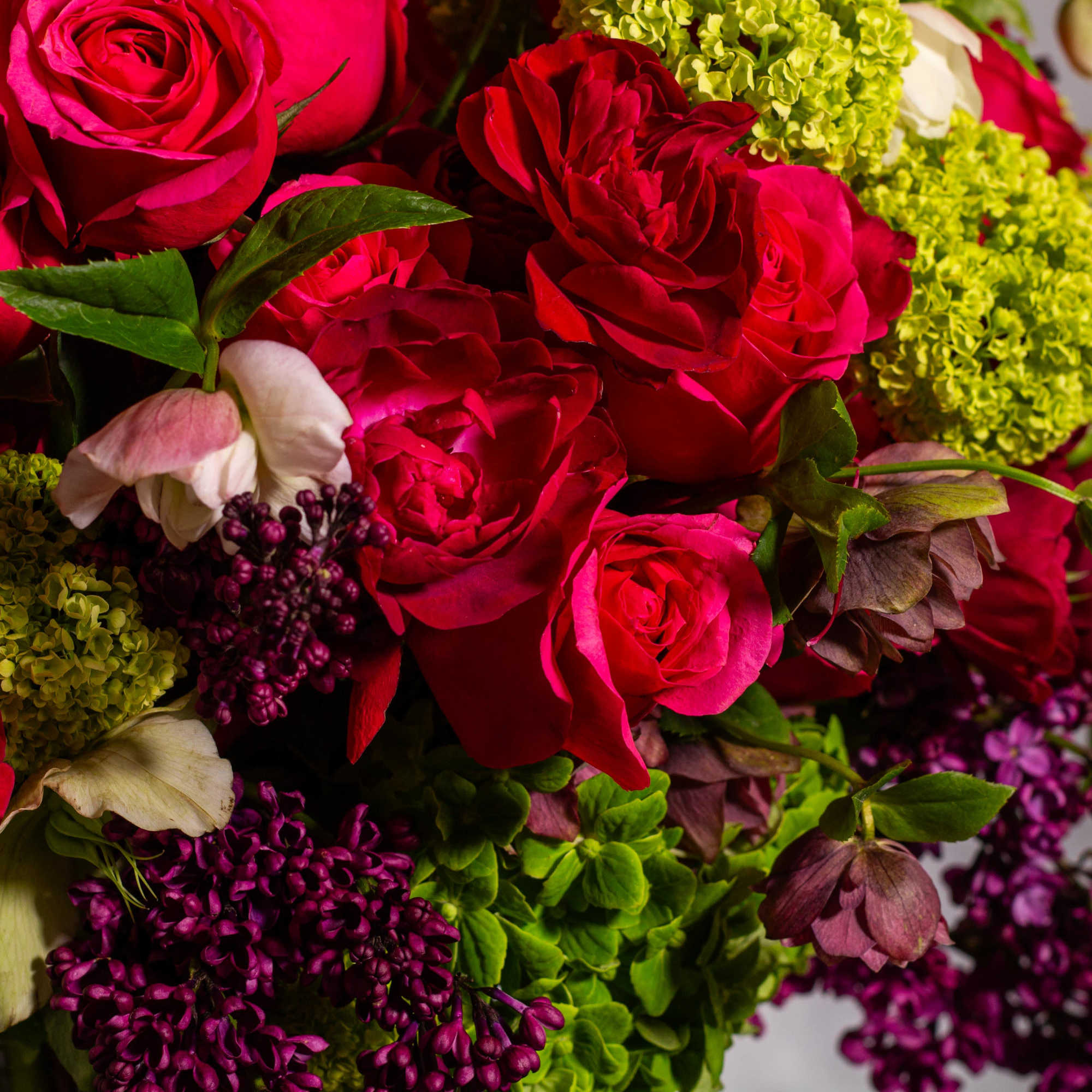 The floral arrangement in the tall crystal vase is truly exquisite. It