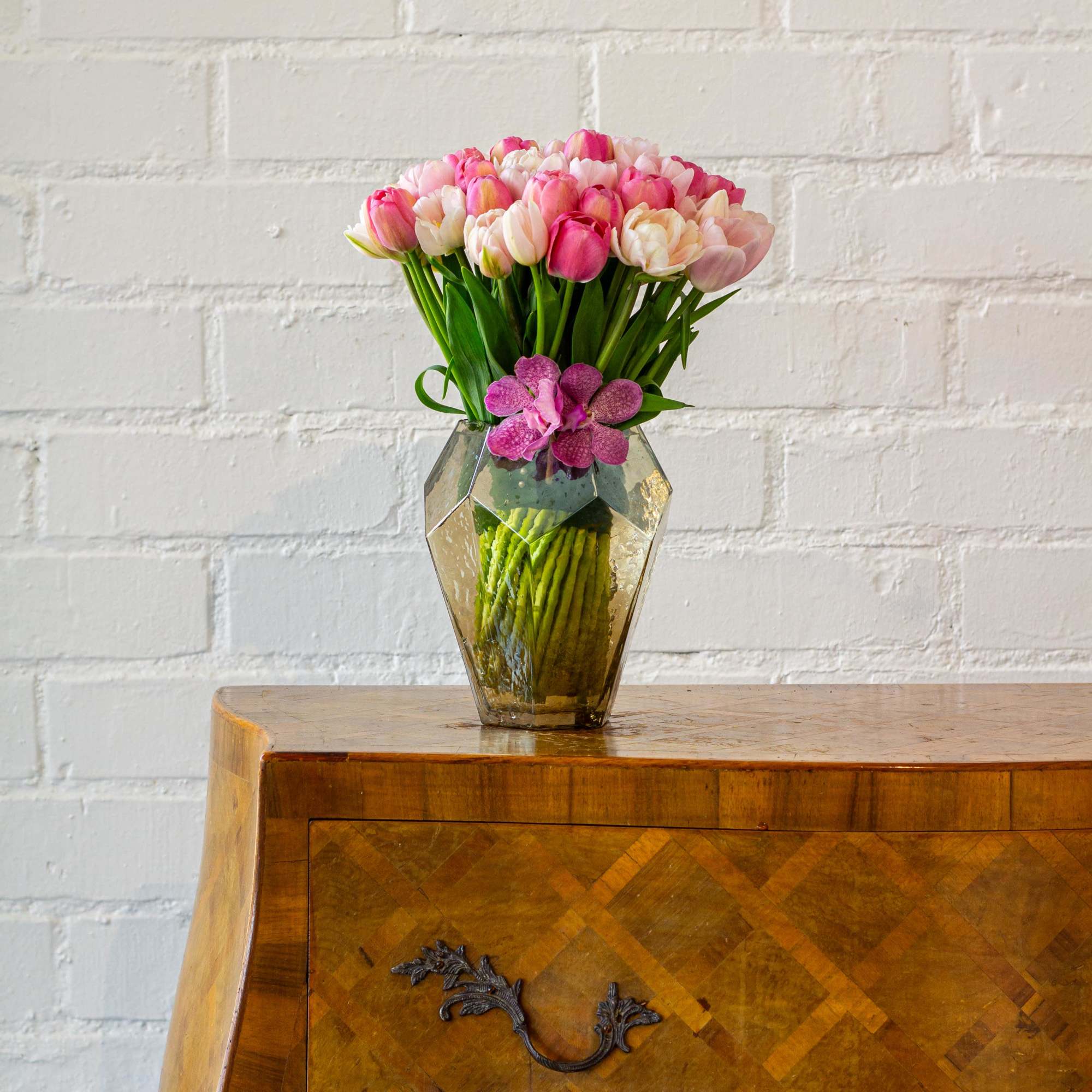 Envision a stunning floral arrangement comprised of fifty light pink and various