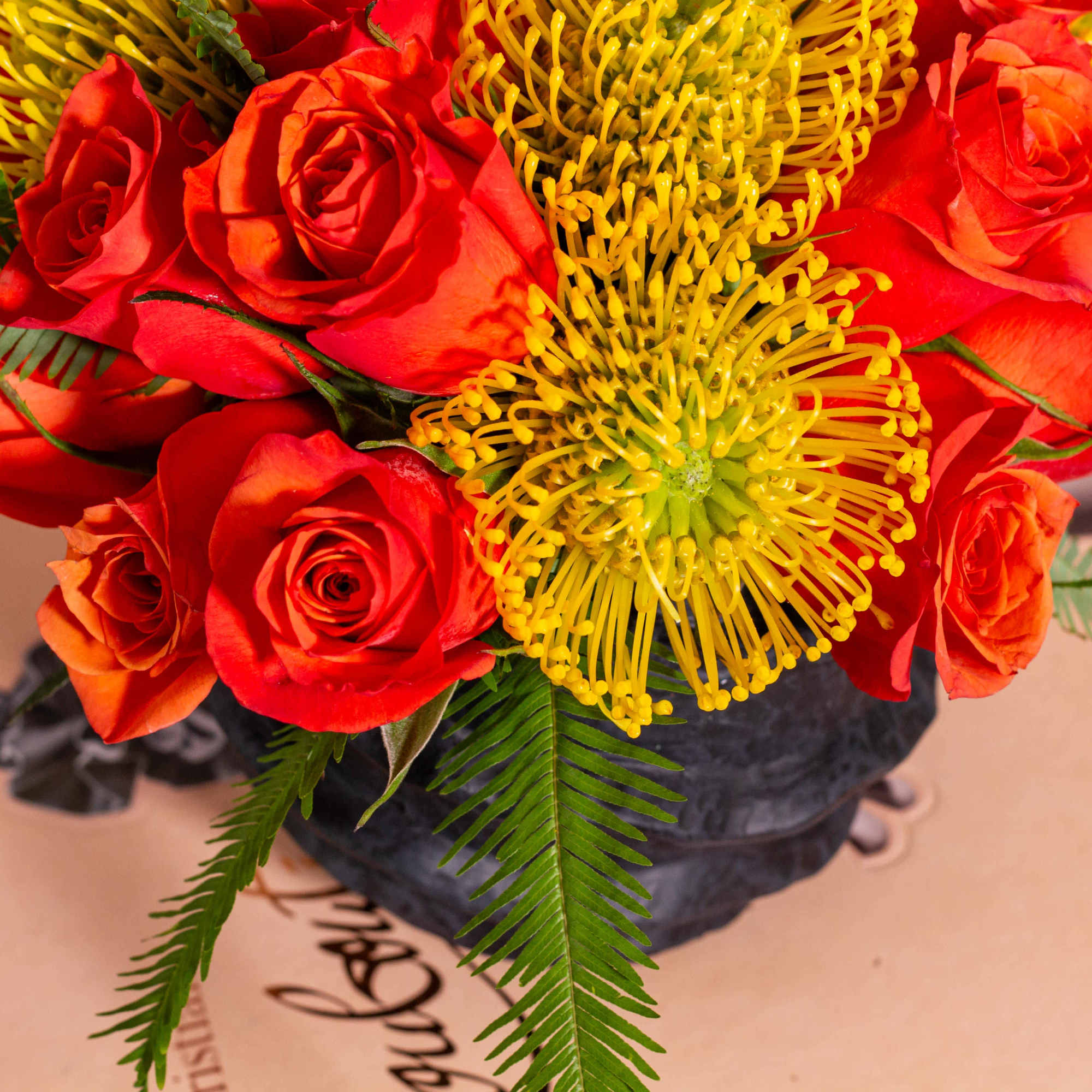 Experience a burst of color with this vibrant arrangement featuring bright orange