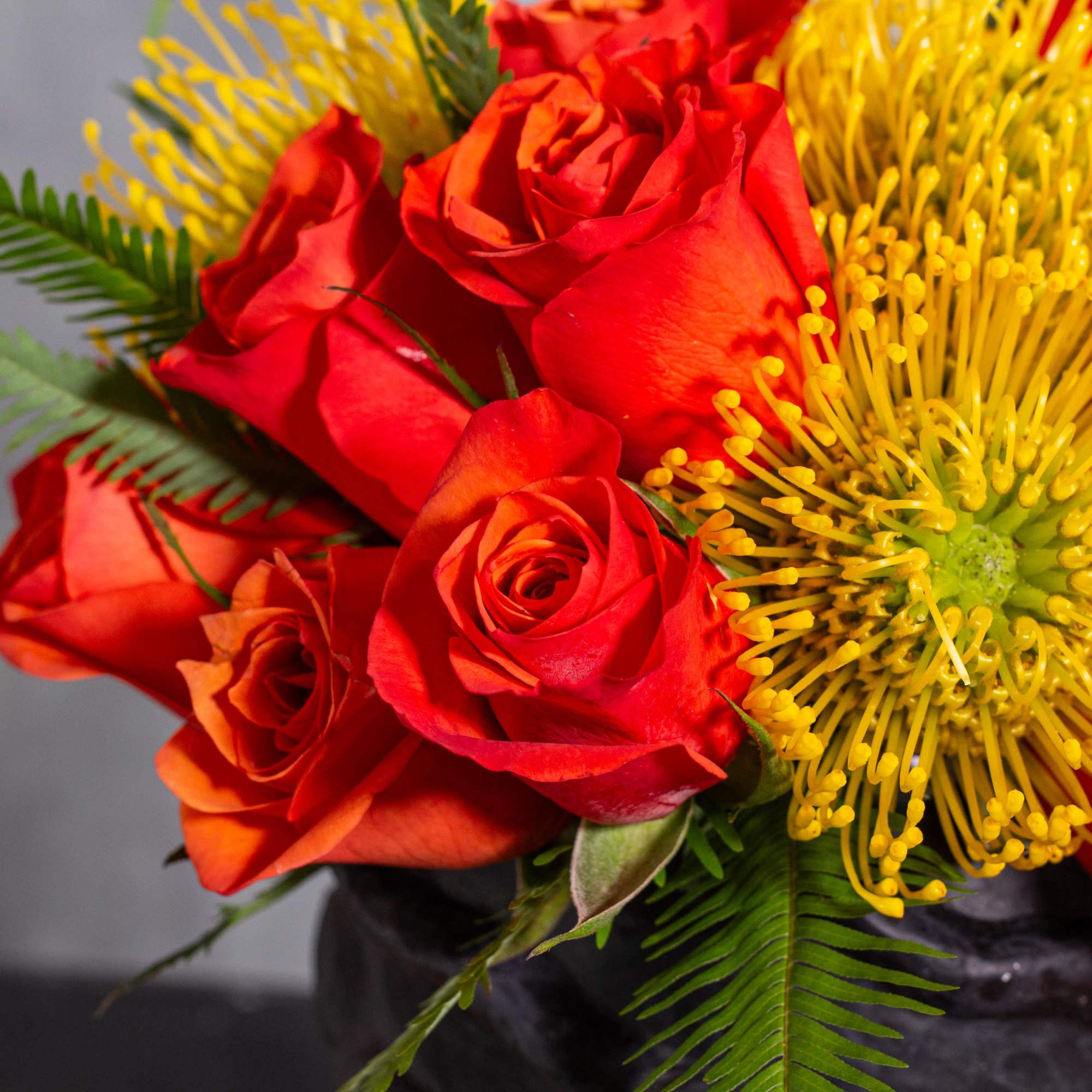 Experience a burst of color with this vibrant arrangement featuring bright orange