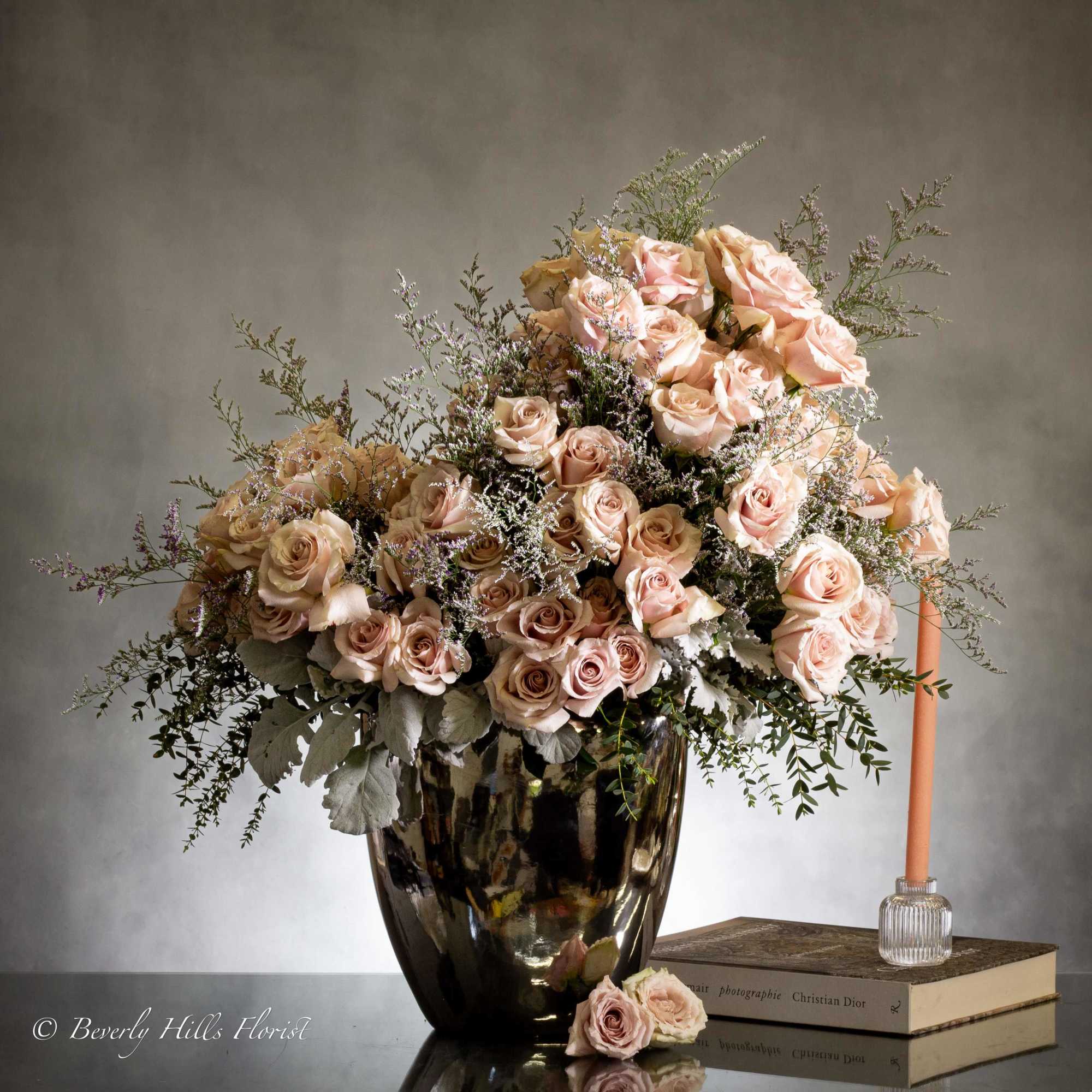 Experience sophistication with a breathtaking arrangement of fifty opulent sand-colored roses in