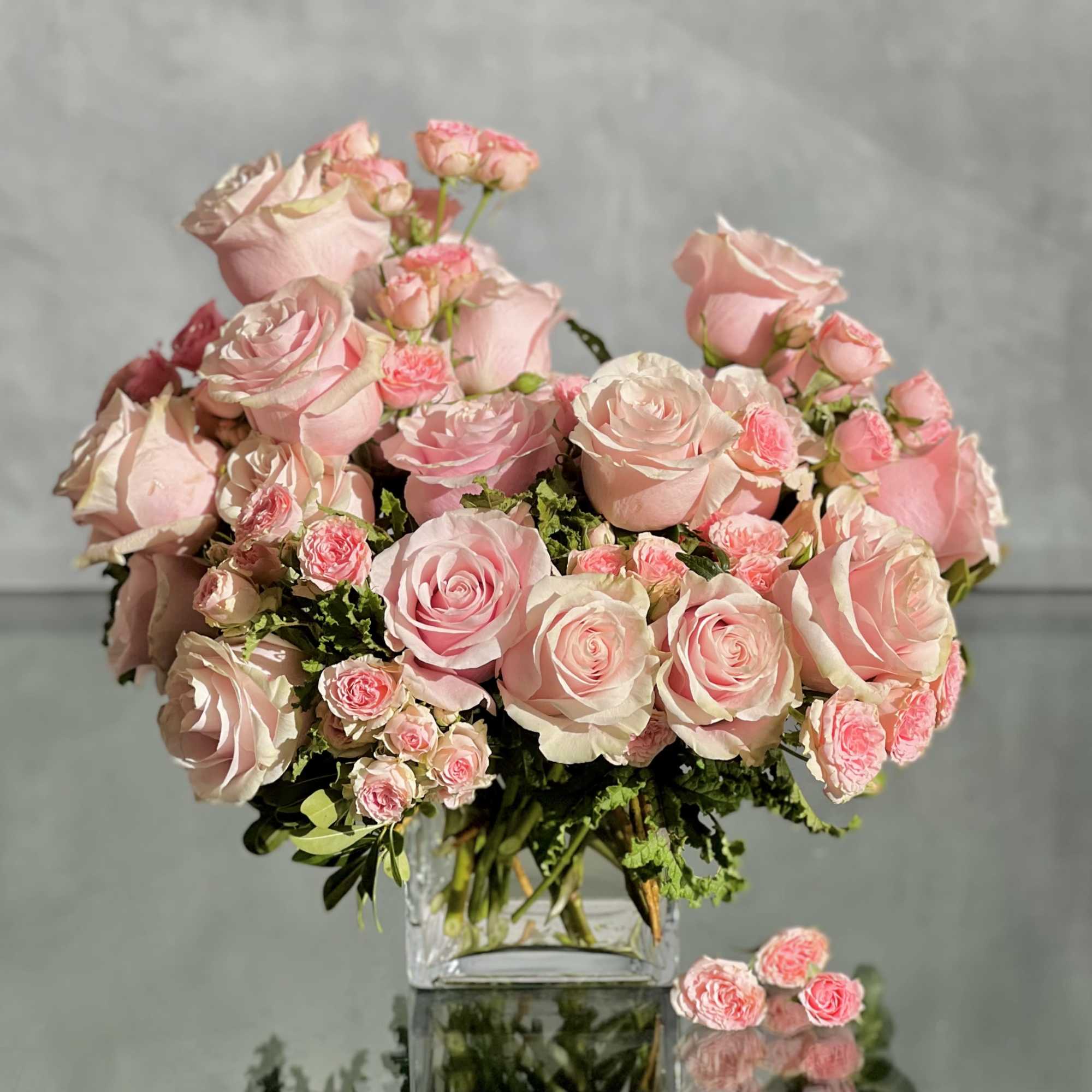 Delight in the luxurious and feminine beauty of our exquisite floral arrangement
