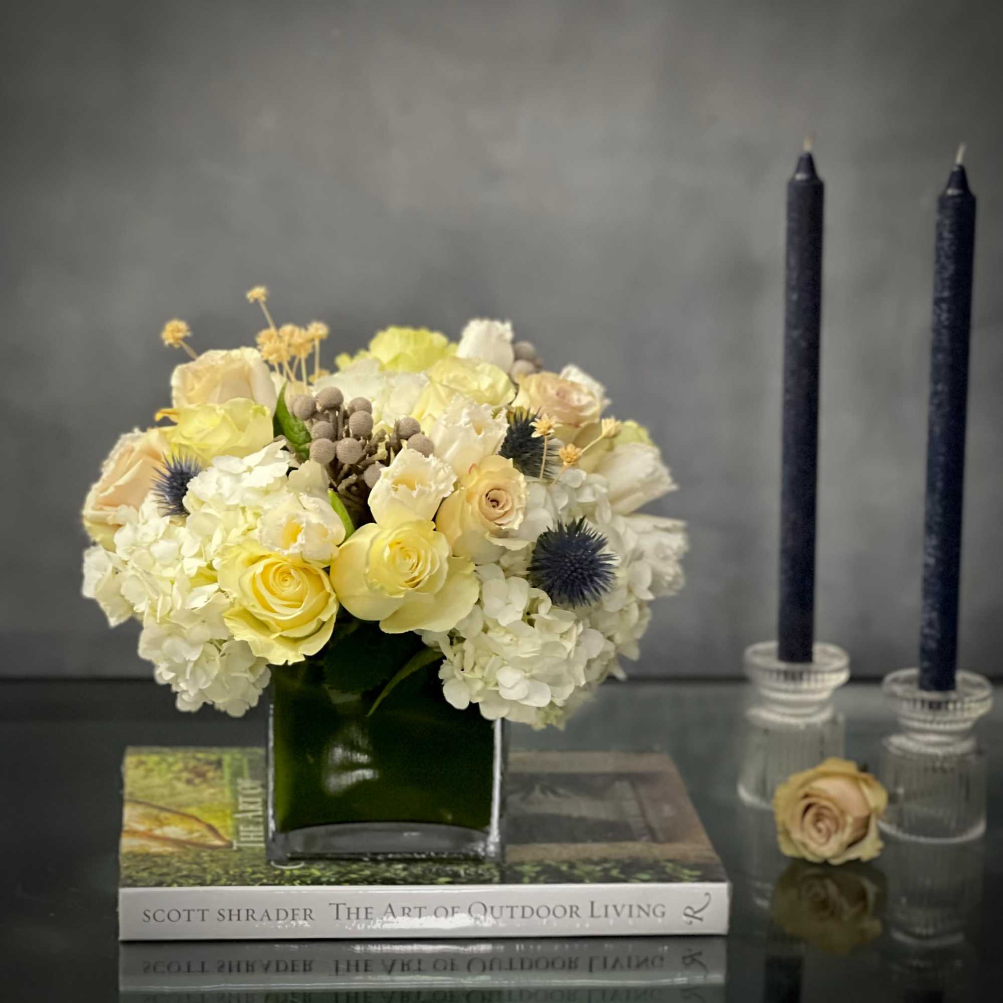 Our beautiful arrangement consists of White Roses, Hydrangeas, Thistles, Cream Roses placed