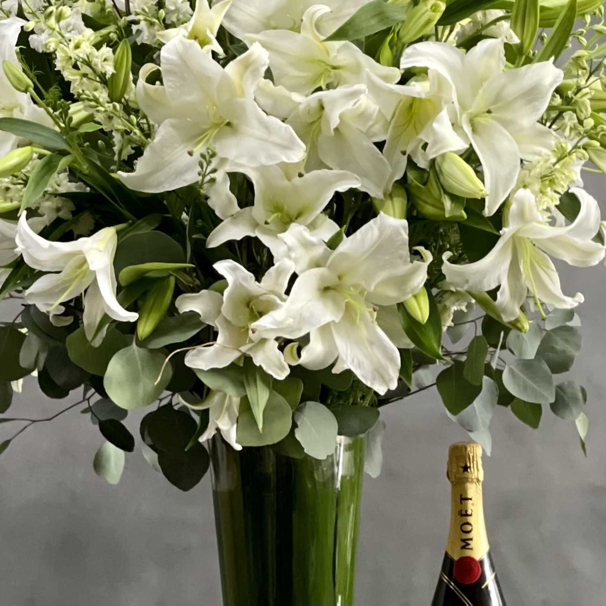 This Display of over 20 Stems of Crystal White Lily&#039;s accented with