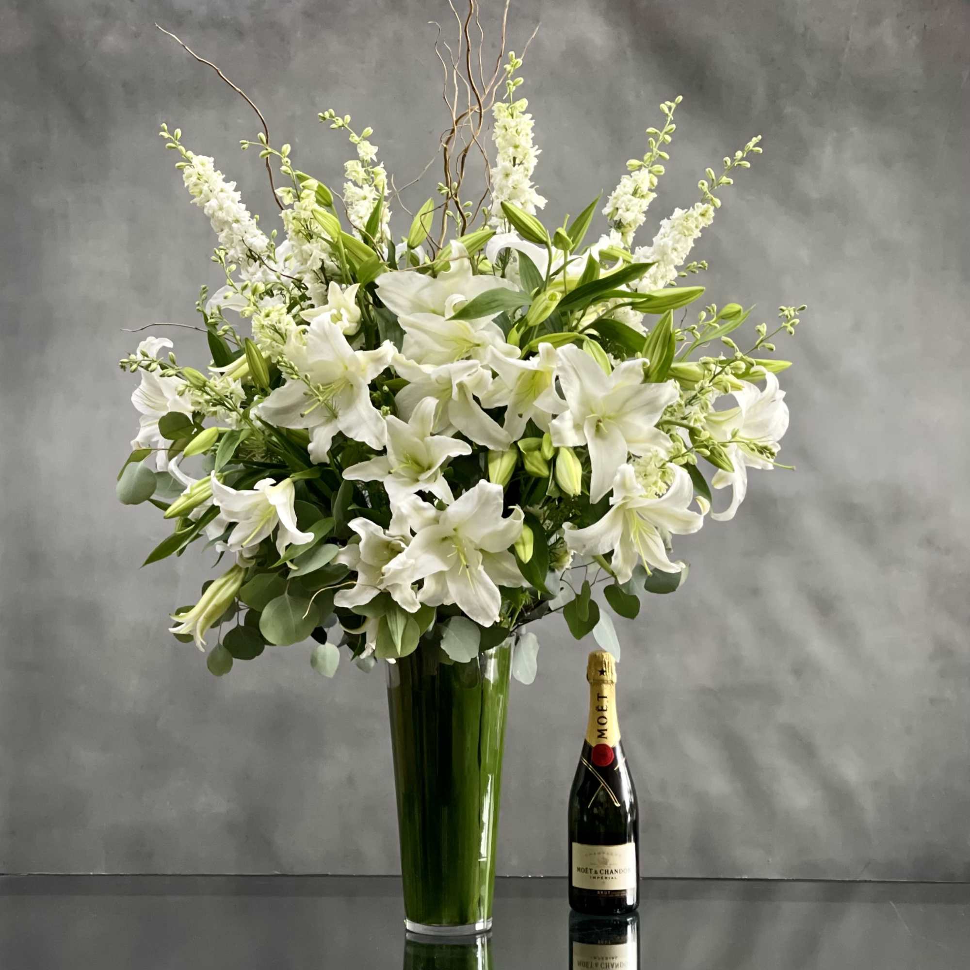 This Display of over 20 Stems of Crystal White Lily&#039;s accented with