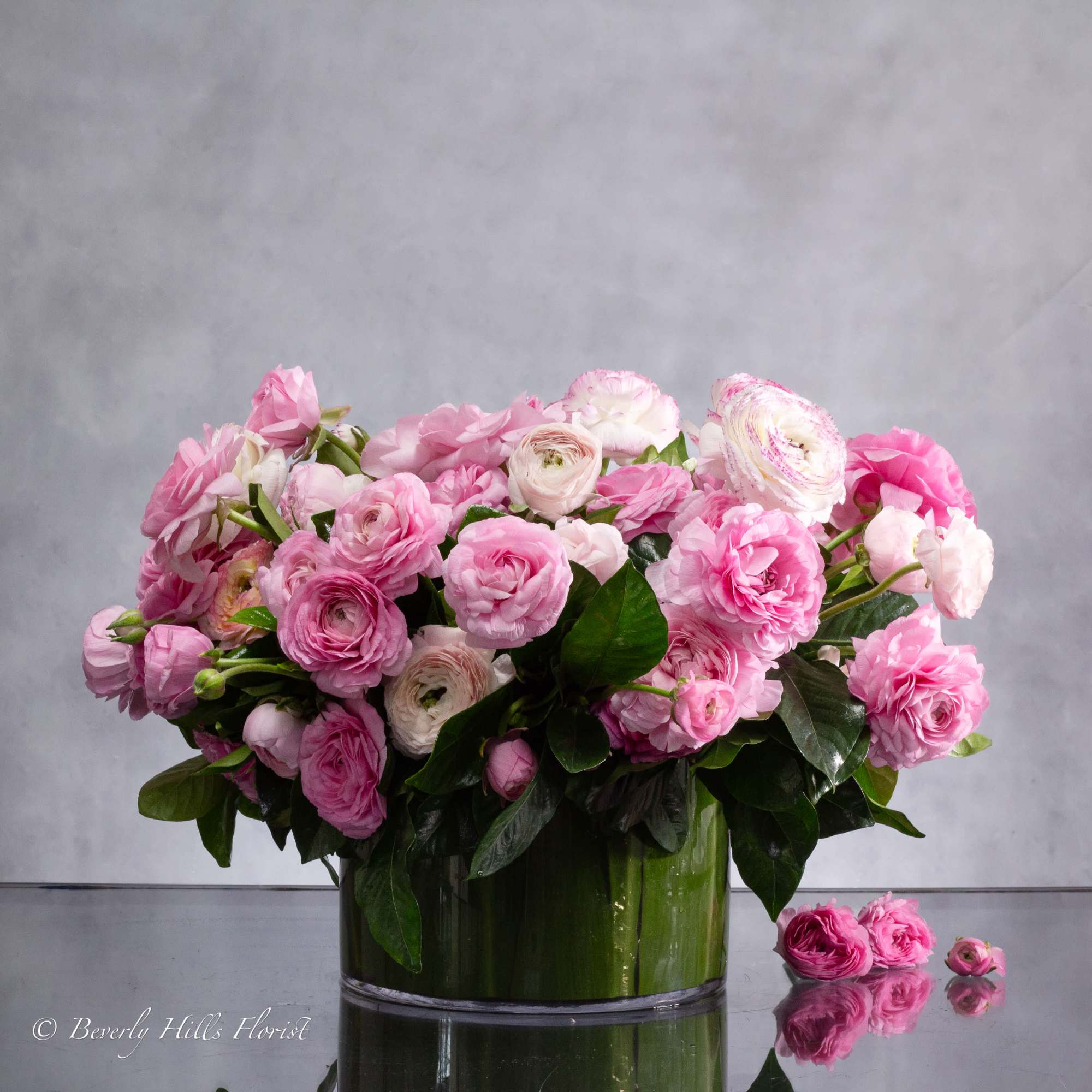 Pink ranunculus symbolize charm, attractiveness, and admiration. When arranged in a cylindrical