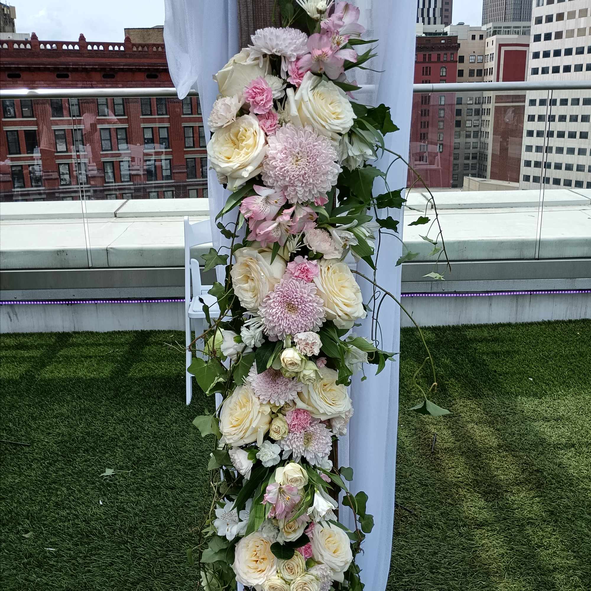 Beautiful white, pink and blush roses, carnations and other flowers huppah decor