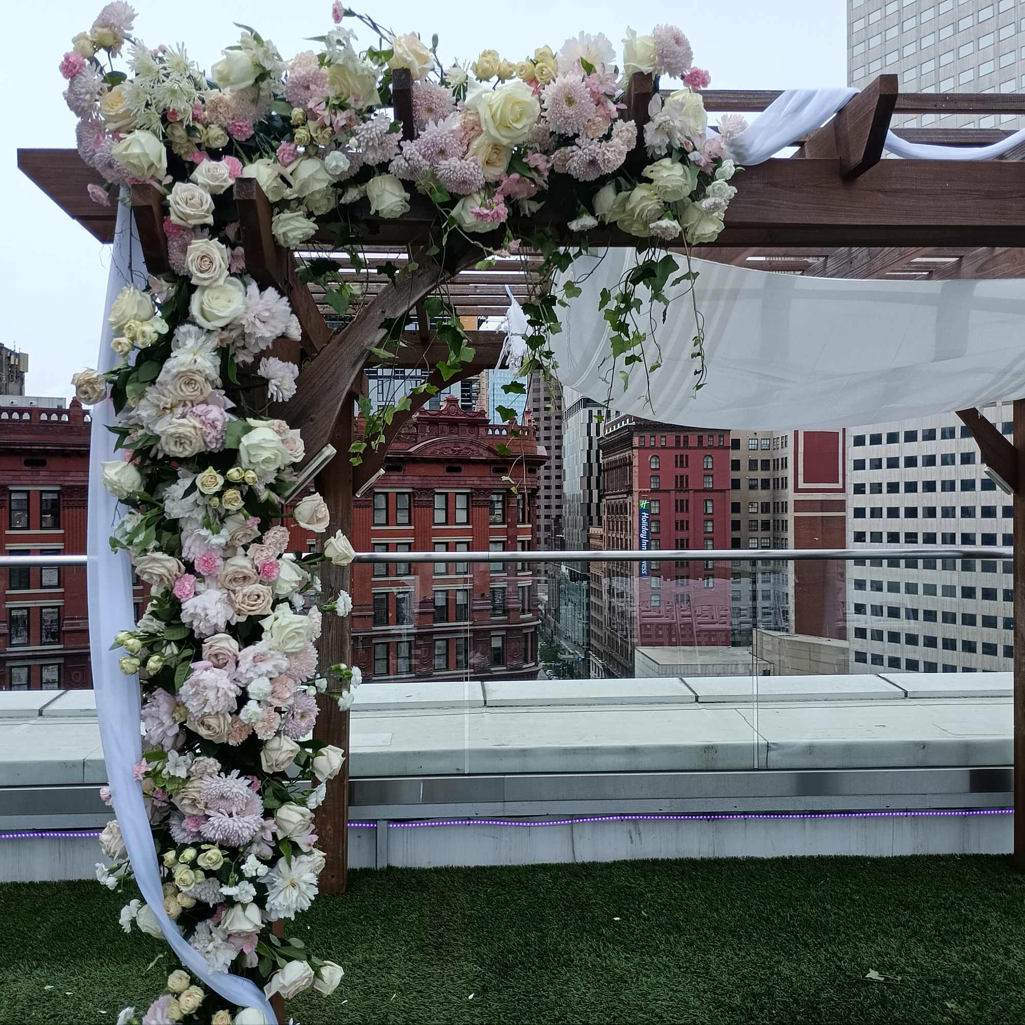 Beautiful white, pink and blush roses, carnations and other flowers huppah decor