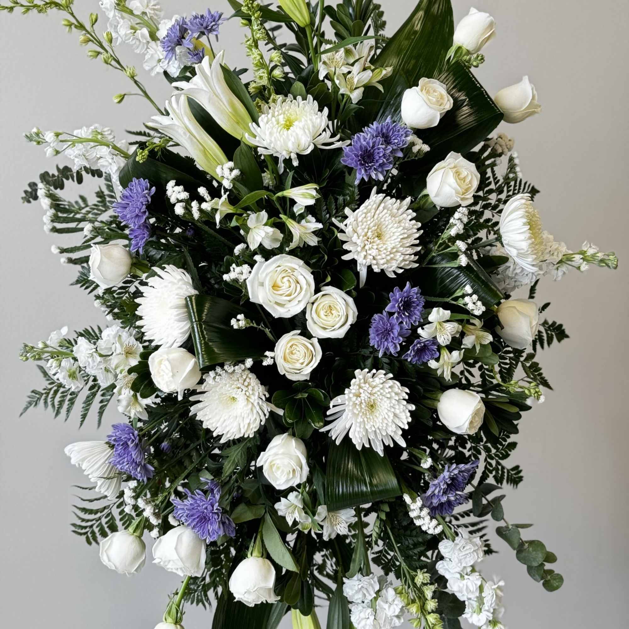 This beautiful spray is arranged with Lillys, cushion mums, lisianthus, white stock This beautiful spray is arranged with Lillys, cushion mums, lisianthus, white stock