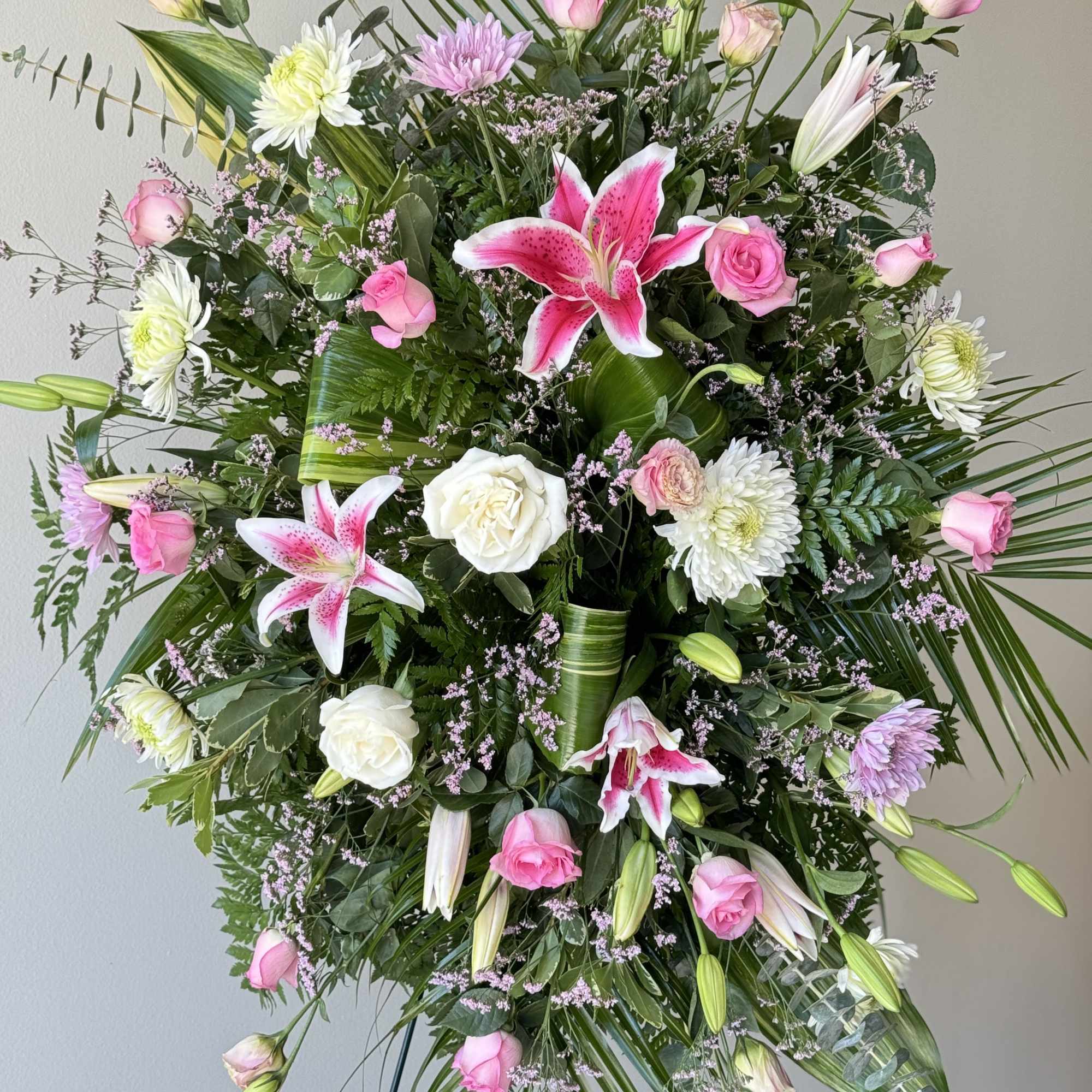 This beautiful spray is arranged with Lillys, cushion mums, lisianthus, white stock This beautiful spray is arranged with Lillys, cushion mums, lisianthus, white stock