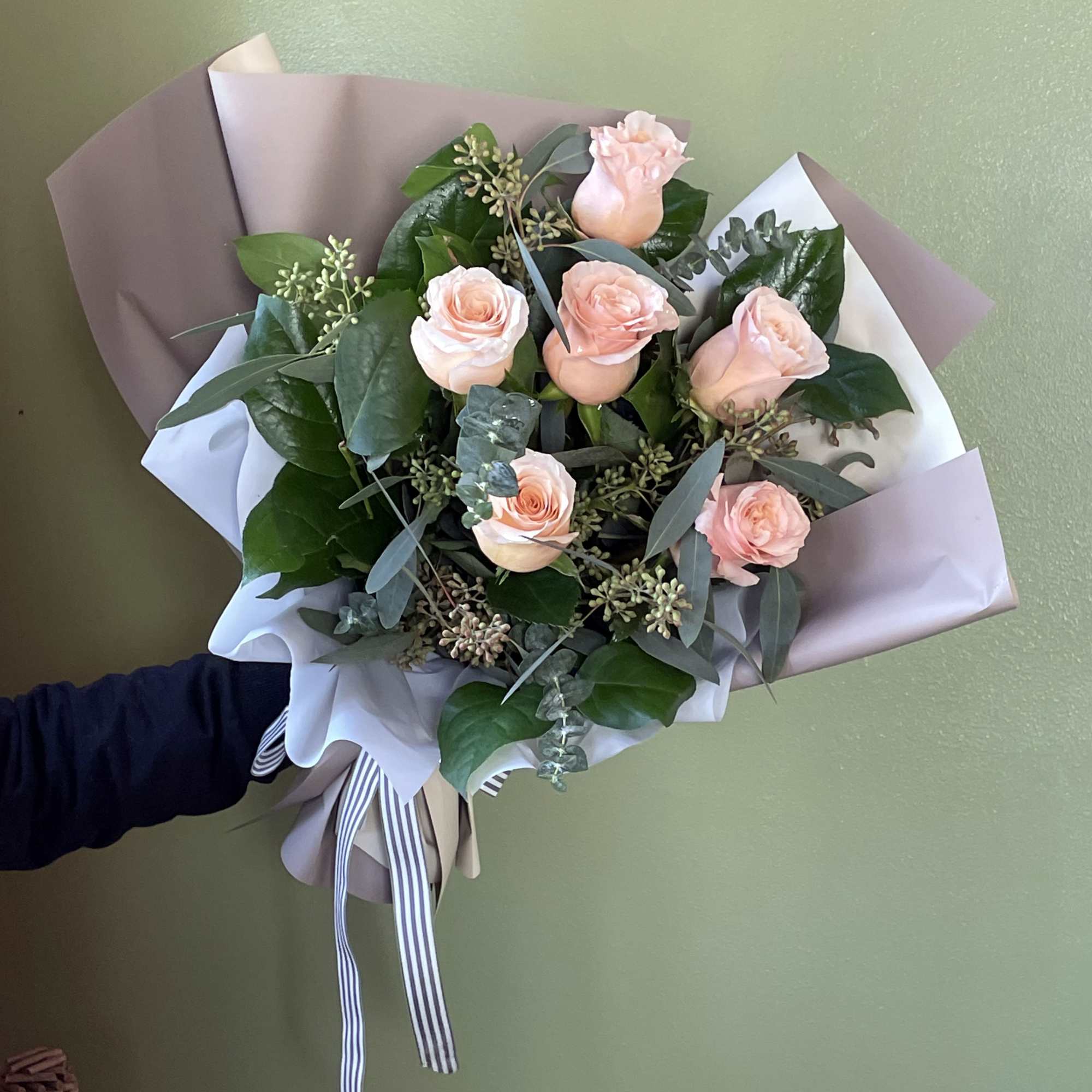 Introducing our stunning dozen Shimmer Peach Roses, elegantly wrapped in premium paper.
