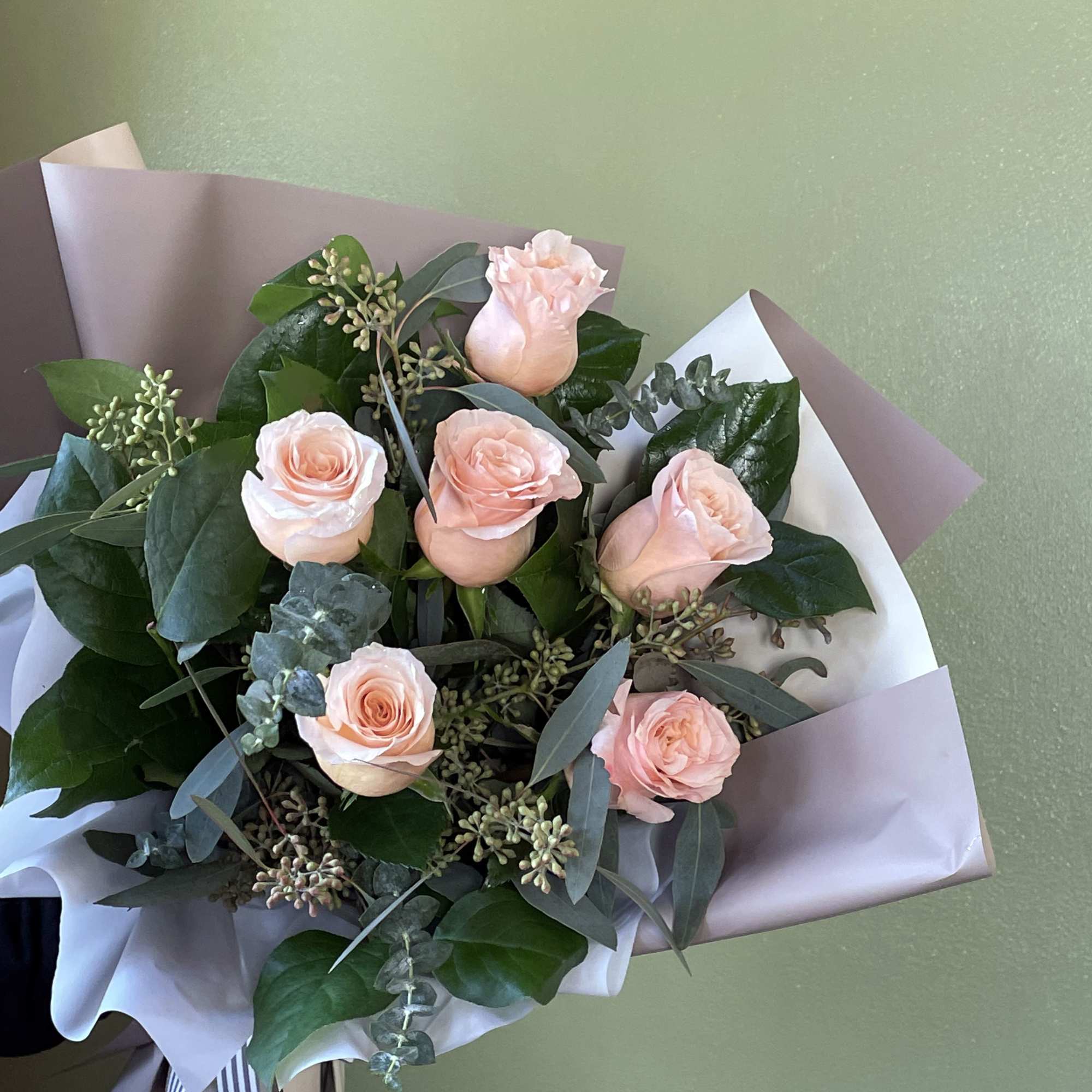 Introducing our stunning dozen Shimmer Peach Roses, elegantly wrapped in premium paper.