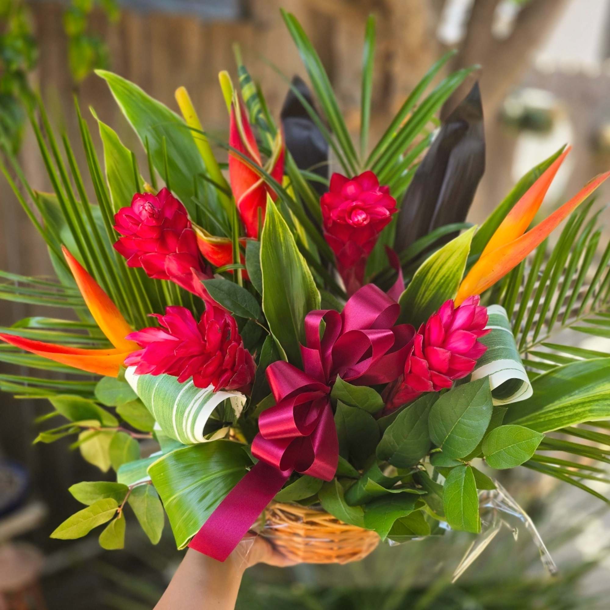 This beautiful tropical floral basket is beaming with bright colors and an