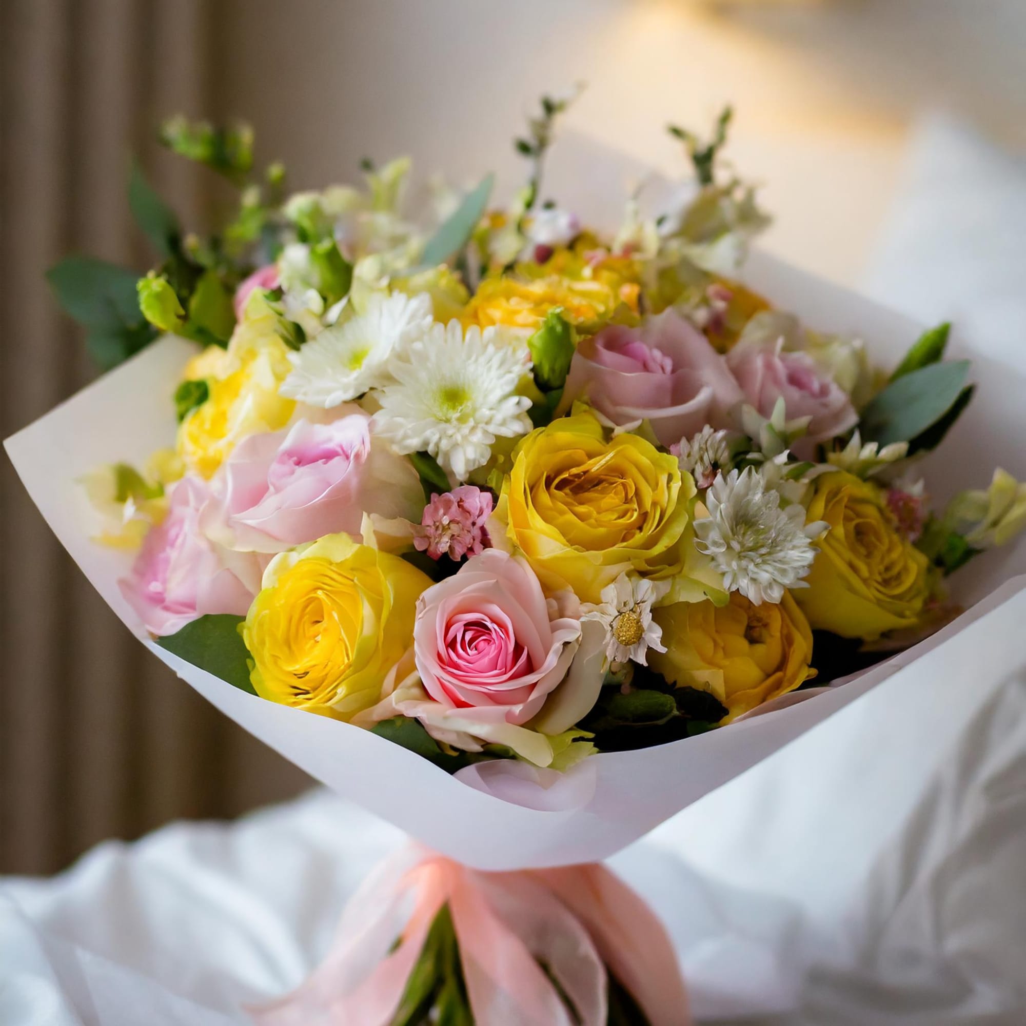A delightful bouquet featuring a charming mix of yellow and white roses